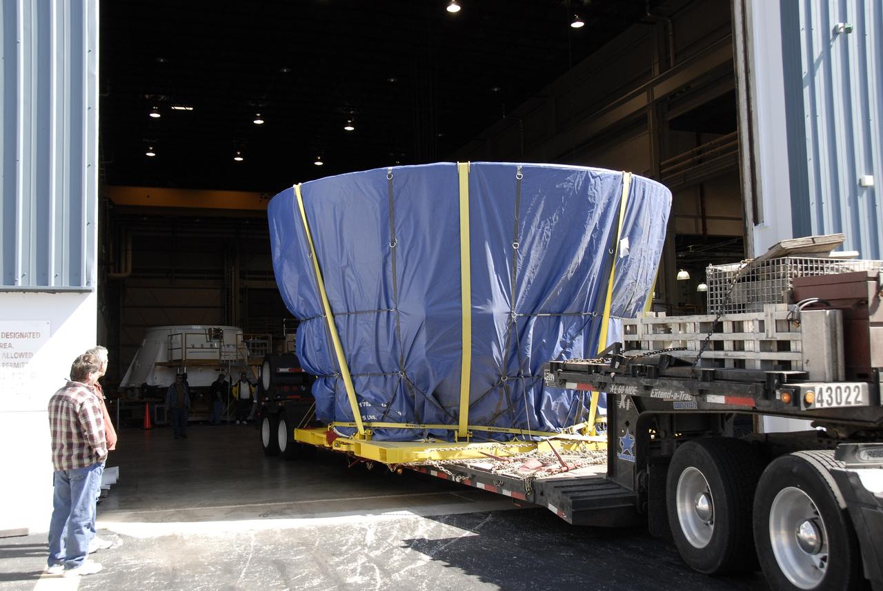 CAPE CANAVERAL, Fla. – The last newly manufactured section of the Ares I-X test rocket, the frustum, is offloaded in the Assembly and Refurbishment Facility of NASA's Kennedy Space Center.  Resembling a giant funnel, the frustum's function is to transition the primary flight loads from the rocket's upper stage to the first stage. The frustum is located between the forward skirt extension and the upper stage of the Ares I-X. Weighing in at approximately 13,000 pounds, the 10-foot-long section is composed of two aluminum rings attached to a truncated conic section. The large diameter of the cone is 18 feet and the small diameter is 12 feet. The cone is 1.25 inches thick. The frustum will be integrated with the forward skirt and forward skirt extension, which already are in the Assembly and Refurbishment Facility. That will complete the forward assembly. The assembly then will be moved to the Vehicle Assembly Building for stacking operations, which are scheduled to begin in April. Manufactured by Major Tool and Machine Inc. in Indiana under a subcontract with Alliant Techsystems Inc., or ATK, the Ares I-X is targeted to launch in the summer of 2009. The flight will provide NASA with an early opportunity to test and prove hardware, facilities and ground operations associated with the Ares I launch vehicle. The flight test also will bring NASA a step closer to its exploration goals of sending humans to the moon and destinations beyond.  Photo credit: NASA/Kim Shiflett