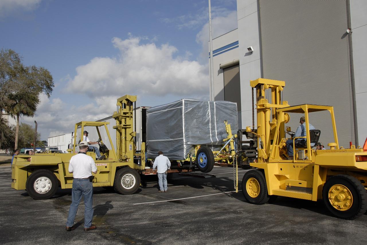 CAPE CANAVERAL, Fla. – At Astrotech in Titusville, Fla., NASA's Lunar CRater Observation and Sensing Satellite, known as LCROSS, is offloaded from the truck after its arrival from Northrop Grumman's facility in Redondo Beach, Calif. The satellite's primary mission is to search for water ice on the moon in a permanently shadowed crater near one of the lunar poles. LCROSS is a low-cost, accelerated-development, companion mission to NASA's Lunar Reconnaissance Orbiter, or LRO. At Kennedy, the two spacecraft will be integrated with an Atlas V launch vehicle and tested for final flight worthiness. LCROSS and LRO are the first missions in NASA's plan to return humans to the moon and begin establishing a lunar outpost by 2020. Photo credit: NASA/Kim Shiflett