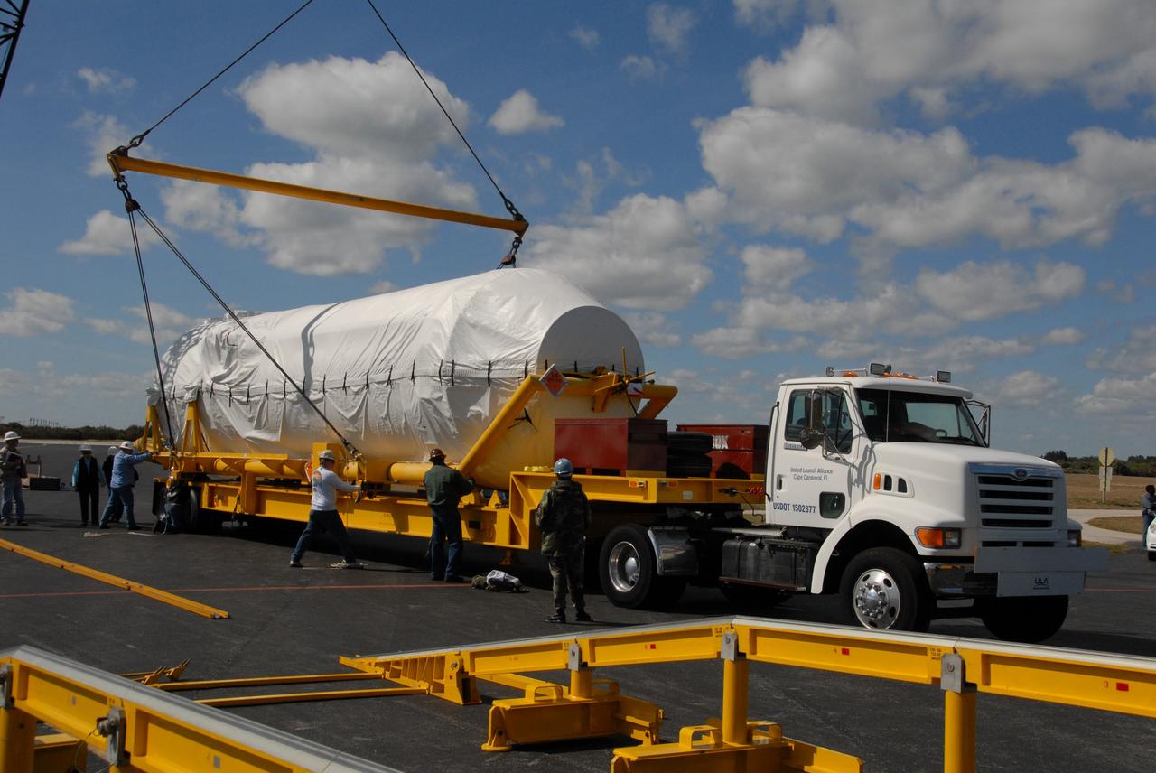 CAPE CANAVERAL, Fla. – With workers assisting, a crane places the Centaur stage of the Atlas V rocket on a flatbed truck on Cape Canaveral Air Force Station's skid strip in Florida. The Centaur will be transported to the Astrotech facility in Titusville, Fla. The Atlas V will launch NASA's Lunar Reconnaissance Orbiter, or LRO, and NASA's Lunar CRater Observation and Sensing Satellite, known as LCROSS. The two spacecraft will be integrated with the Atlas V and tested for final flight worthiness. Launch is scheduled for the spring. LCROSS and LRO are the first missions in NASA's plan to return humans to the moon and begin establishing a lunar outpost by 2020. Photo credit: NASA/Cory Huston