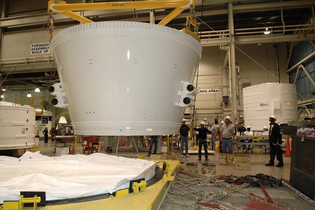 CAPE CANAVERAL, Fla. – In the Assembly and Refurbishment Facility, or ARF, at NASA's Kennedy Space Center, an overhead crane lifts the frustum for the Ares I-X test rocket from its transporter. The frustum is the last manufactured section of the Ares I-X. The frustum will be moved from the transporter to supports on the floor. Resembling a giant funnel, the frustum's function is to transition the primary flight loads from the rocket's upper stage to the first stage. The frustum is located between the forward skirt extension and the upper stage of the Ares I-X.  The frustum will be integrated with the forward skirt and forward skirt extension, which already are in the ARF. That will complete the forward assembly. The assembly then will be moved to the Vehicle Assembly Building for stacking operations, which are scheduled to begin in April.  Photo credit: NASA/Kim Shiflett