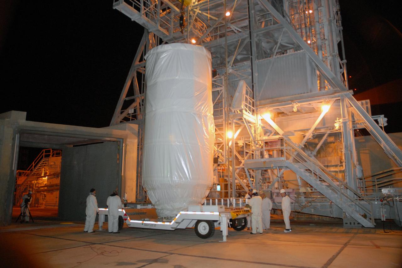 CAPE CANAVERAL, Fla. – Covered by a protective cover, NASA's Kepler spacecraft arrives on Launch pad 17-B at Cape Canaveral Air Force Station in Florida. Kepler will be lifted into the mobile service tower for mating with the Delta II rocket for launch. The liftoff of Kepler is currently scheduled for 10:48 p.m. EST March 5. Kepler is designed to survey more than 100,000 stars in our galaxy to determine the number of sun-like stars that have Earth-size and larger planets, including those that lie in a star's "habitable zone," a region where liquid water, and perhaps life, could exist. If these Earth-size worlds do exist around stars like our sun, Kepler is expected to be the first to find them and the first to measure how common they are. Photo credit: NASA/Jack Pfaller
