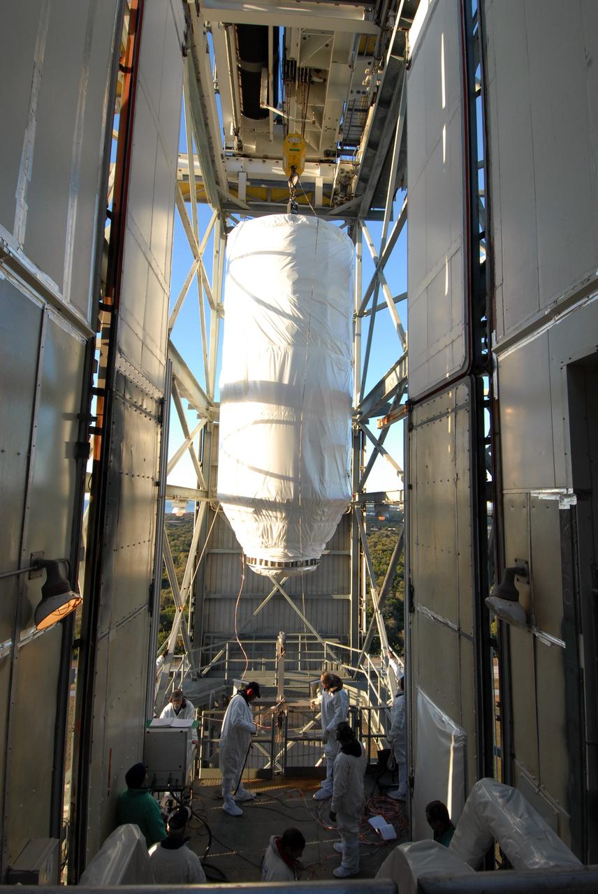 CAPE CANAVERAL, Fla. – On Launch pad 17-B at Cape Canaveral Air Force Station in Florida, workers prepare to move NASA's Kepler spacecraft into the mobile service tower where it will be mated with the Delta II rocket for launch. The liftoff of Kepler is currently scheduled for 10:48 p.m. EST March 5. Kepler is designed to survey more than 100,000 stars in our galaxy to determine the number of sun-like stars that have Earth-size and larger planets, including those that lie in a star's "habitable zone," a region where liquid water, and perhaps life, could exist. If these Earth-size worlds do exist around stars like our sun, Kepler is expected to be the first to find them and the first to measure how common they are. Photo credit: NASA/Jack Pfaller