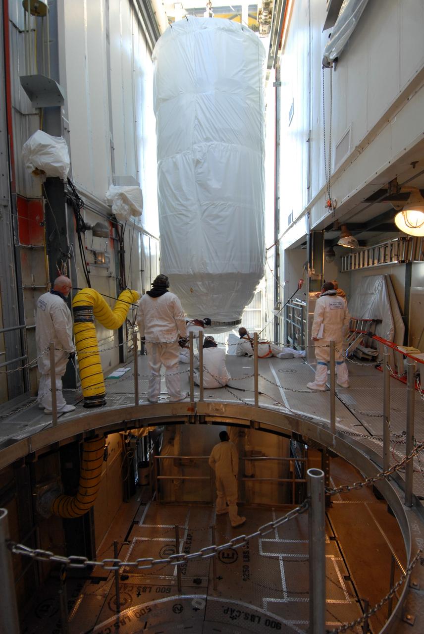 CAPE CANAVERAL, Fla. – On Launch pad 17-B at Cape Canaveral Air Force Station in Florida, workers move NASA's Kepler spacecraft into the mobile service tower where it will be mated with the Delta II rocket for launch. The liftoff of Kepler is currently scheduled for 10:48 p.m. EST March 5. Kepler is designed to survey more than 100,000 stars in our galaxy to determine the number of sun-like stars that have Earth-size and larger planets, including those that lie in a star's "habitable zone," a region where liquid water, and perhaps life, could exist. If these Earth-size worlds do exist around stars like our sun, Kepler is expected to be the first to find them and the first to measure how common they are. Photo credit: NASA/Jack Pfaller