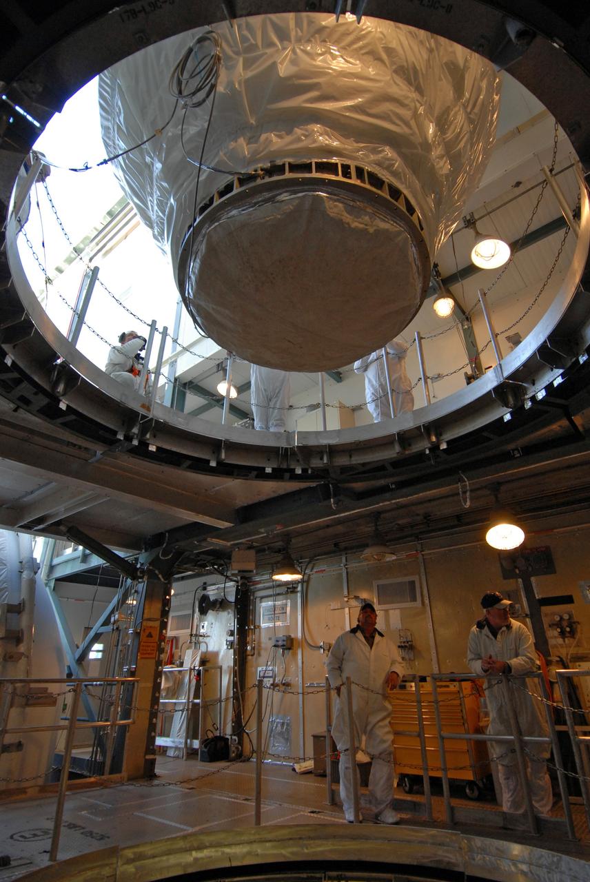 CAPE CANAVERAL, Fla. – On Launch pad 17-B at Cape Canaveral Air Force Station in Florida, workers move NASA's Kepler spacecraft toward the opening above the Delta II rocket. The spacecraft will be lowered into the opening and mated with the Delta II for launch. The liftoff of Kepler is currently scheduled for 10:48 p.m. EST March 5. Kepler is designed to survey more than 100,000 stars in our galaxy to determine the number of sun-like stars that have Earth-size and larger planets, including those that lie in a star's "habitable zone," a region where liquid water, and perhaps life, could exist. If these Earth-size worlds do exist around stars like our sun, Kepler is expected to be the first to find them and the first to measure how common they are. Photo credit: NASA/Jack Pfaller