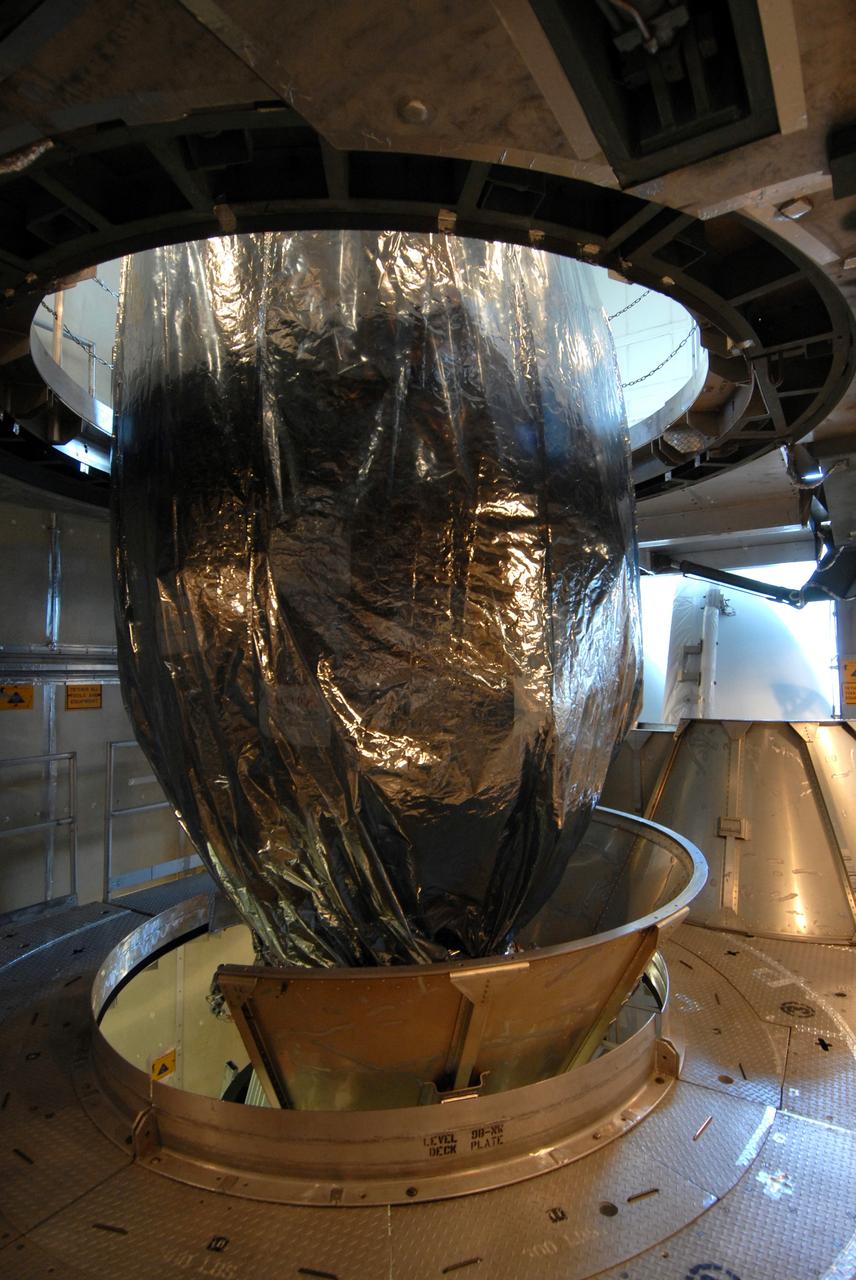 CAPE CANAVERAL, Fla. –  In the mobile service tower on Launch pad 17-B at Cape Canaveral Air Force Station in Florida, the lower part of the metal transportation canister is removed from around NASA's Kepler spacecraft.  The spacecraft was mated with the Delta II rocket for launch. The liftoff of Kepler is currently scheduled for 10:48 p.m. EST March 5. Kepler is designed to survey more than 100,000 stars in our galaxy to determine the number of sun-like stars that have Earth-size and larger planets, including those that lie in a star's "habitable zone," a region where liquid water, and perhaps life, could exist. If these Earth-size worlds do exist around stars like our sun, Kepler is expected to be the first to find them and the first to measure how common they are.   Photo credit: NASA/Jack Pfaller