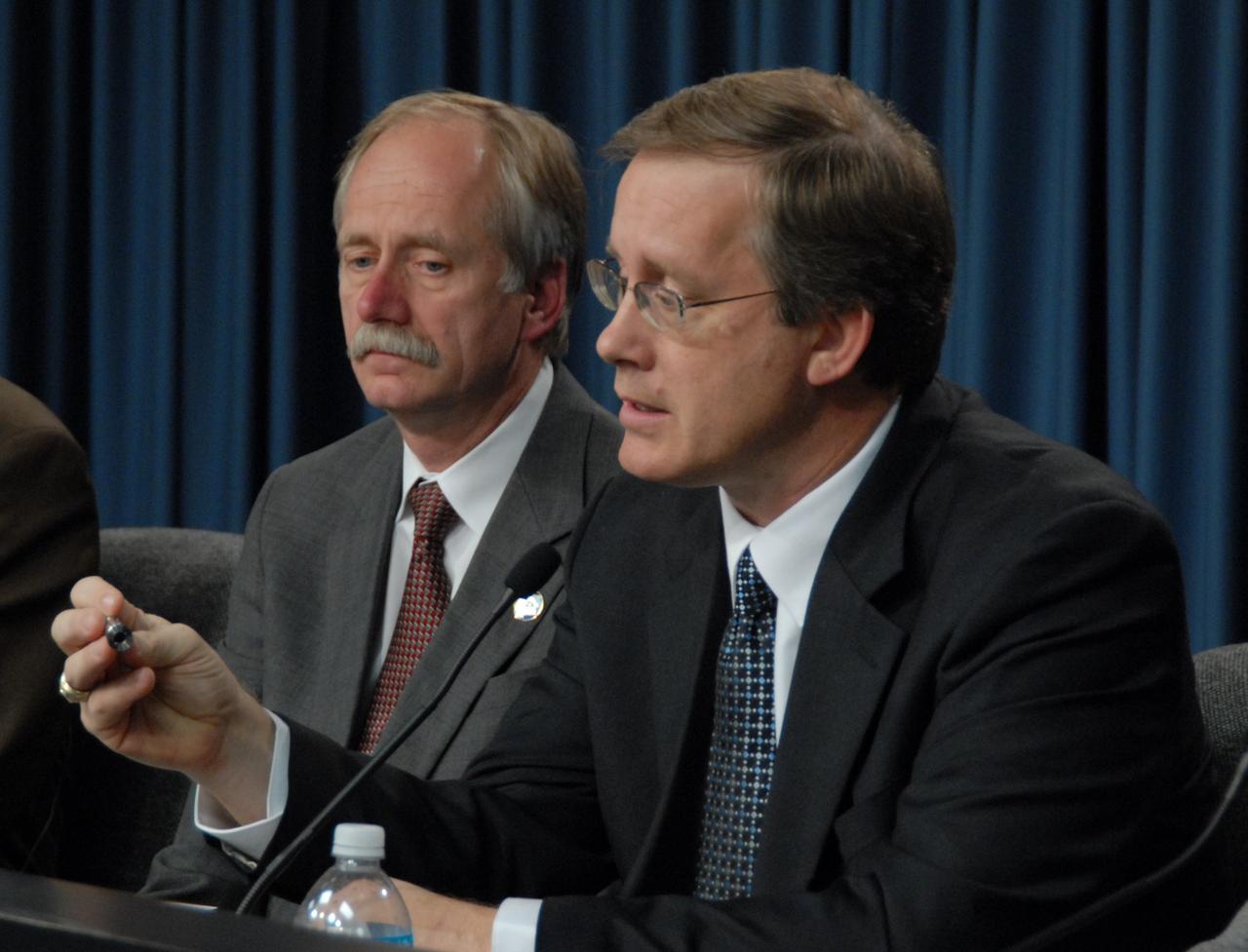 CAPE CANAVERAL, Fla. – At the flight readiness review news conference for space shuttle Discovery's STS-119 mission, Space Shuttle Program Manager John Shannon (right) talks about the discussion surrounding Discovery's readiness for flight. At left is Associate Administrator for Space Operations Bill Gerstenmaier. Shannon is holding a flow control valve that is under review and testing. Engineering teams have been working to identify what caused damage to a flow control valve on shuttle Endeavour during its November 2008 flight. A new launch date has not been determined. Photo credit: NASA/Glenn Benson