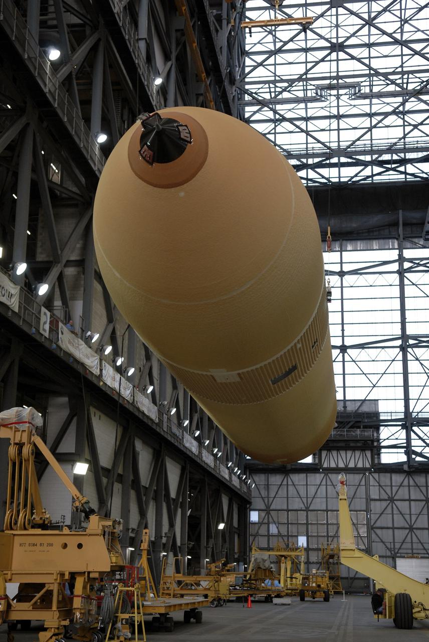 CAPE CANAVERAL, Fla. – In the transfer aisle of the Vehicle Assembly Building at NASA's Kennedy Space Center in Florida, external fuel tank ET-131 is lifted from its transporter.  It will be raised to vertical and then lifted into the upper levels and lowered into a checkout bay.  ET-131 will be used on space shuttle Endeavour's  STS-127 mission.  Payload for the mission is the Japanese Experiment Module's Experiment Logistics Module-Exposed Section, or ELM-ES.  Launch is targeted for June.  Photo credit: NASA/Kim Shiflett