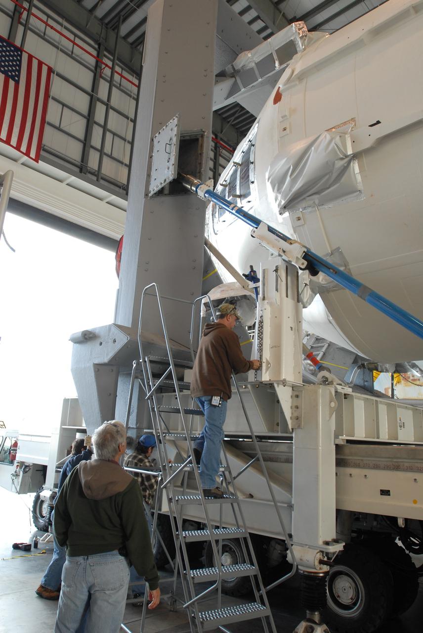 CAPE CANAVERAL, Fla. – On Complex 37 at Cape Canaveral Air Force Station in Florida, workers ensure the GOES-O and Delta IV second stage are ready to leave the Horizontal Integration Facility for the launch pad. GOES-O is one of a series of Geostationary Operational Environmental Satellites. The multi-mission GOES series N-P will be a vital contributor to weather, solar and space operations and science. NASA and the National Oceanic and Atmospheric Administration, or NOAA, are actively engaged in a cooperative program to expand the existing GOES system with the launch of the GOES N-P satellites. Launch of the GOES-O is targeted for no earlier than April 2009. Photo credit: NASA/Jim Grossmann