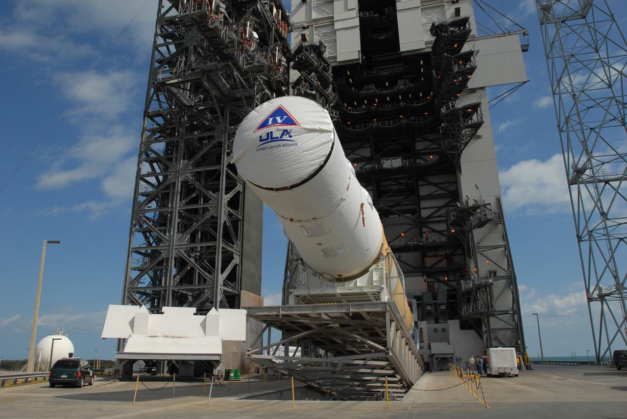 CAPE CANAVERAL, Fla. – On Launch Pad 37 at Cape Canaveral Air Force Station in Florida, the GOES-O and Delta IV upper stage are being raised to vertical. They will be moved into the mobile service tower for prelaunch preparations. GOES–O is one of a series of Geostationary Operational Environmental Satellites. The multi-mission GOES series N-P will be a vital contributor to weather, solar and space operations and science. NASA and the National Oceanic and Atmospheric Administration, or NOAA, are actively engaged in a cooperative program to expand the existing GOES system with the launch of the GOES N-P satellites. Launch of the GOES-O is targeted for no earlier than April 2009. Photo credit: NASA/Jim Grossmann