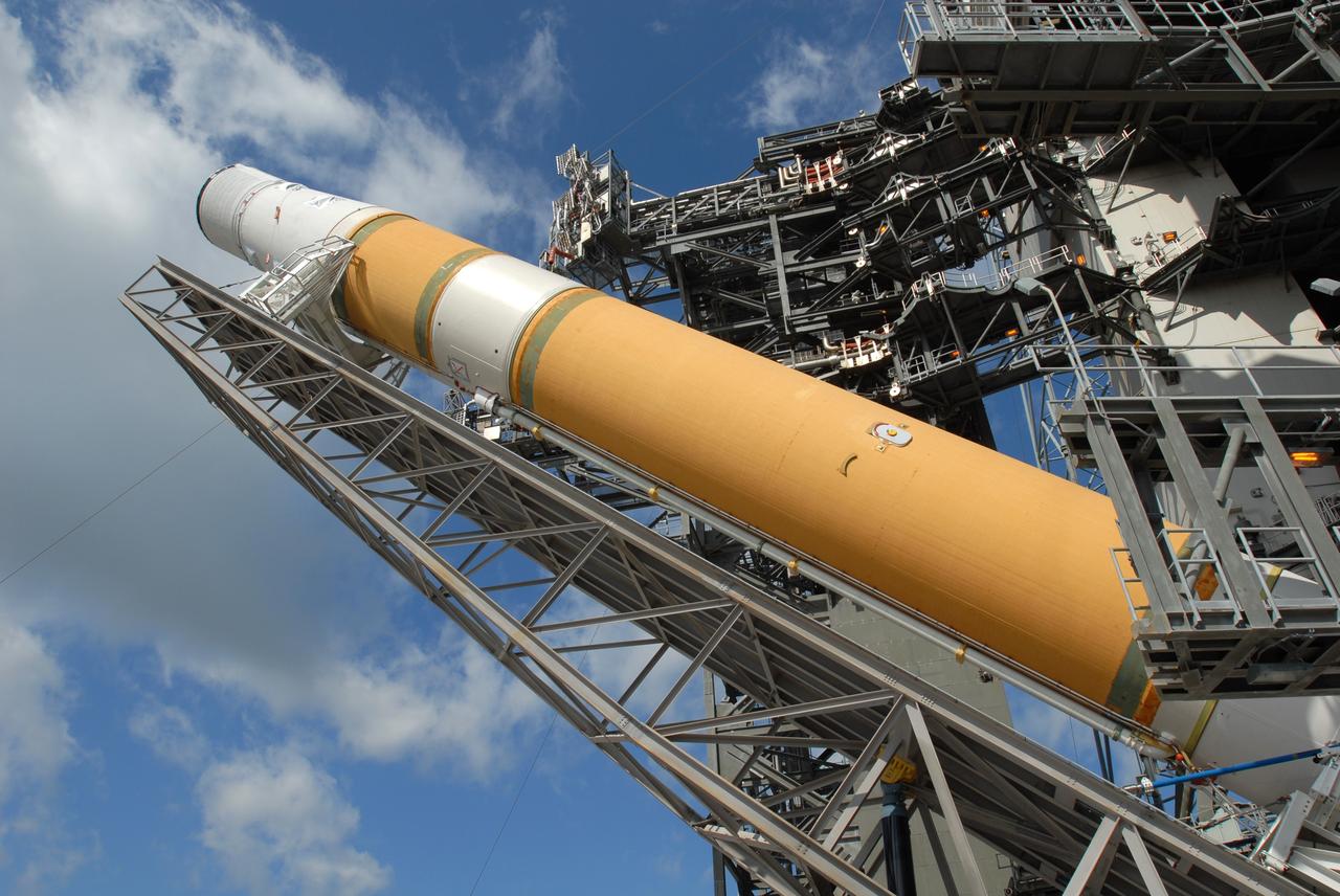 CAPE CANAVERAL, Fla. – On Launch Pad 37 at Cape Canaveral Air Force Station in Florida, the GOES-O and Delta IV upper stage are being raised to vertical. They will be moved into the mobile service tower for prelaunch preparations. GOES–O is one of a series of Geostationary Operational Environmental Satellites. The multi-mission GOES series N-P will be a vital contributor to weather, solar and space operations and science. NASA and the National Oceanic and Atmospheric Administration, or NOAA, are actively engaged in a cooperative program to expand the existing GOES system with the launch of the GOES N-P satellites. Launch of the GOES-O is targeted for no earlier than April 2009. Photo credit: NASA/Jim Grossmann