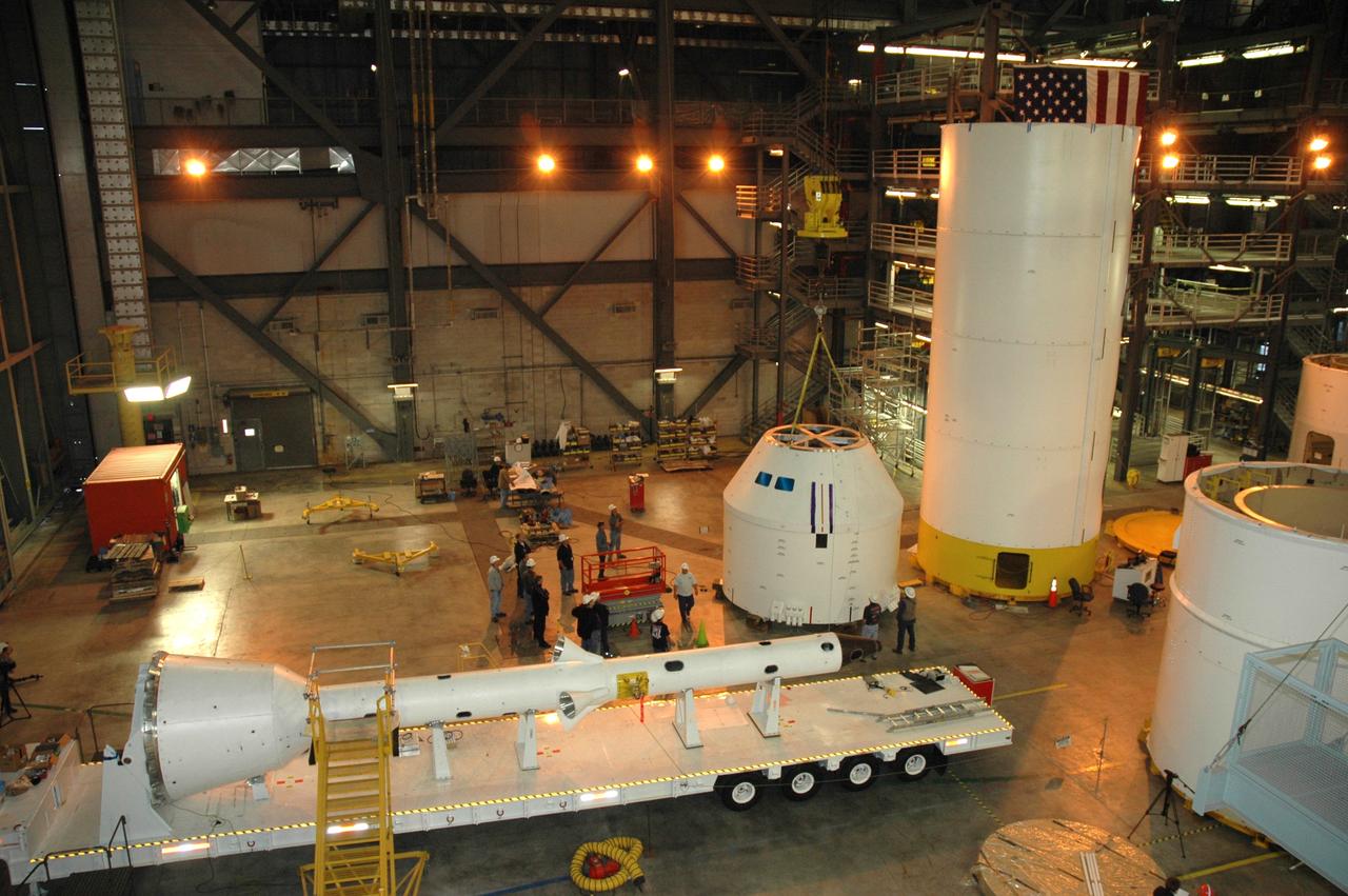 CAPE CANAVERAL, Fla. – In high bay 4 of the Vehicle Assembly Building at NASA's Kennedy Space Center in Florida, the Ares I-X crew/service module simulator (center right) is being moved following a fit check.  Next to it are Ares I-X segments  stacked.  In the foreground is a launch abort system that, with the module, will form the tip of the rocket.  Ares I-X is the test flight for the Ares I.   The I-X flight will provide NASA an early opportunity to test and prove hardware, facilities and ground operations associated with Ares I. The launch of the 327-foot-tall, full-scale Ares I-X, targeted for July 2009, will be the first in a series of unpiloted rocket launches from Kennedy. When fully developed, the 16-foot diameter crew module will furnish living space and reentry protection for the astronauts.  Photo credit: NASA/Tim Jacobs