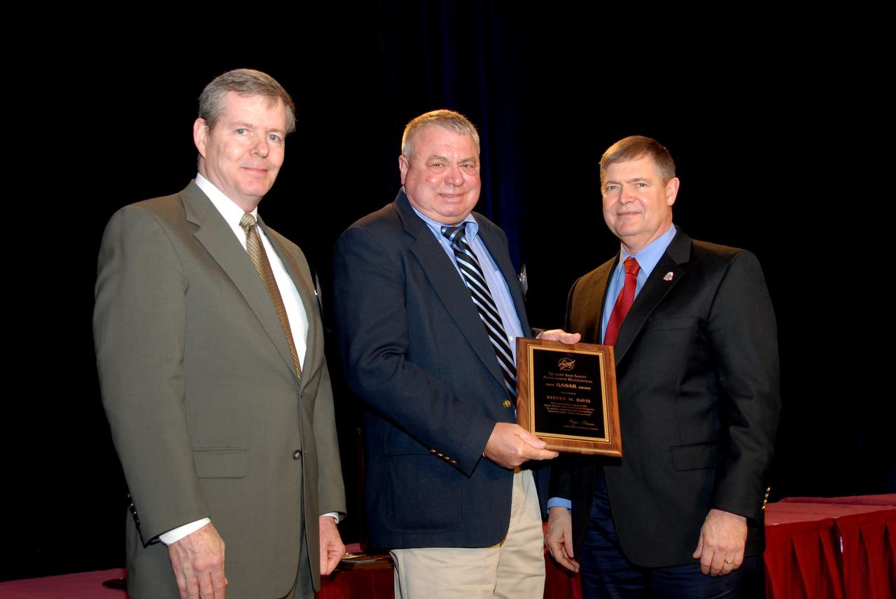 CAPE CANAVERAL, Fla. – NASA's Chief Safety and Mission Assurance Officer, Bryan D. O'Connor (left), presents a Quality and Safety Achievement Recognition, or QASAR, award for 2008 to Steven M. Davis (center).  Davis, an employee of the Defense Contract Management Agency at NASA's Kennedy Space Center, received the award for his attention to detail in an incident involving a space shuttle solid rocket booster.  At right is Dr. Michael Ryschkewitsch, NASA's chief engineer. Davis received the award at NASA's sixth annual Project Management Challenge in Daytona Beach, Fla.  The QASAR award recognizes individual government and contractor employees who have demonstrated exemplary performance in contributing to the quality and/or safety of products, services, processes or management programs and activities. Photo credit: NASA/Ben Smegelsky
