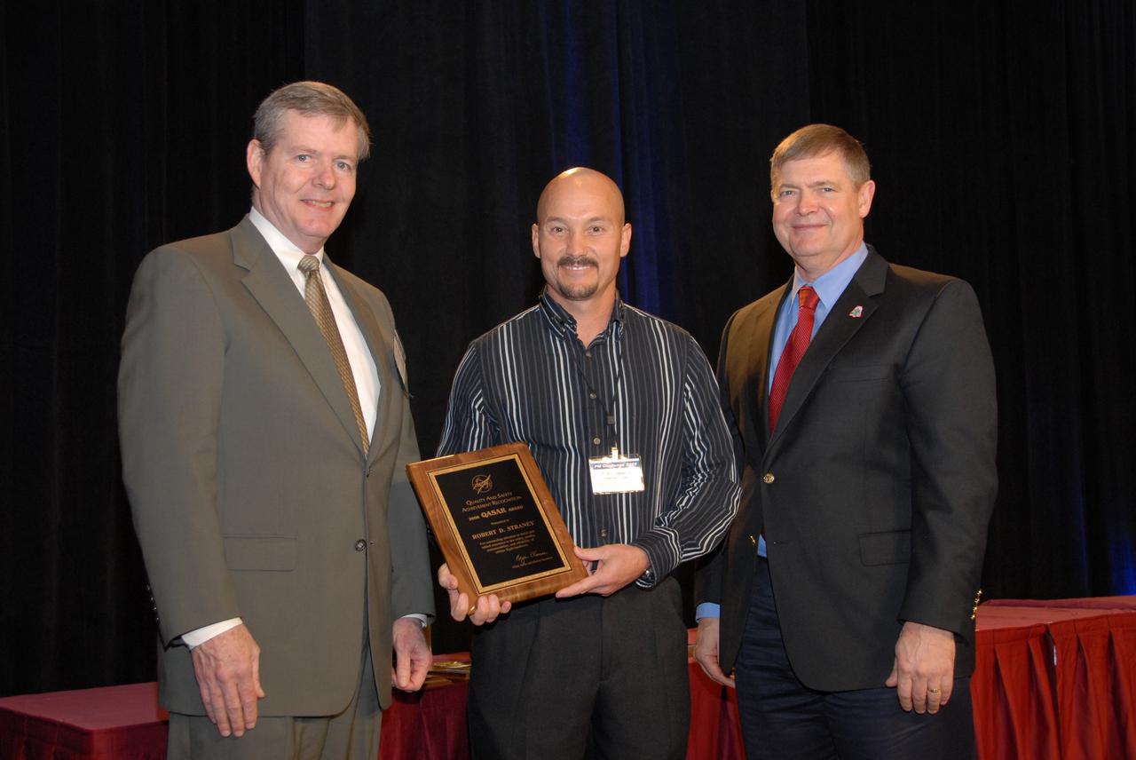 CAPE CANAVERAL, Fla. – NASA's Chief Safety and Mission Assurance Officer, Bryan D. O'Connor (left), presents a Quality and Safety Achievement Recognition, or QASAR, award for 2008 to Robert D. Straney (center).  Straney, an employee of United Space Alliance at NASA's Kennedy Space Center in Florida, received the award for his attention to detail in an inspection of the space shuttle Discovery. At right is Dr. Michael Ryschkewitsch, NASA's chief engineer.  Straney received the award at NASA's sixth annual Project Management Challenge in Daytona Beach, Fla. The QASAR award recognizes individual government and contractor employees who have demonstrated exemplary performance in contributing to the quality and/or safety of products, services, processes or management programs and activities. Photo credit: NASA/Ben Smegelsky