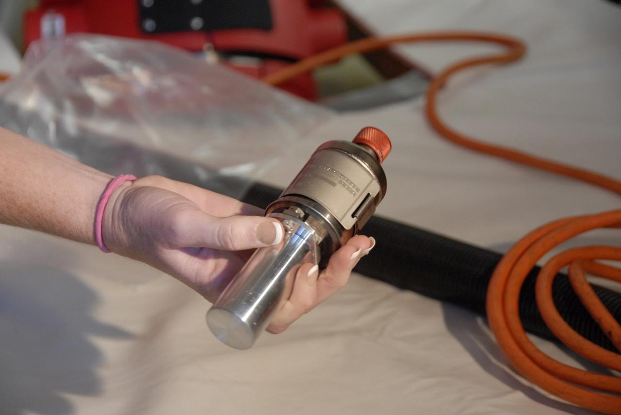 CAPE CANAVERAL, Fla. – On Launch Pad 39A at NASA's Kennedy Space Center in Florida, a technician holds one of space shuttle Discovery's gaseous hydrogen flow control valves after its removal. Two of the three valves being removed will undergo detailed inspection. Part of the main propulsion system, the valves channel gaseous hydrogen from the main engines to the external tank. NASA and contractor teams have been working to identify what caused damage to a flow control valve on shuttle Endeavour during its November 2008 flight. Approximately 4,000 images of each valve removed will be reviewed for evidence of cracks. Valves that have flown fewer times will be installed in Discovery. NASA's Space Shuttle Program has established a plan that could support shuttle Discovery's launch to the International Space Station, tentatively targeted for March 12. An exact target launch date will be determined as work on the valves progresses. Photo credit: NASA/Dimitri Gerondidakis