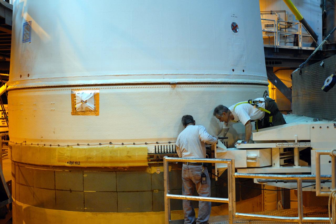 CAPE CANAVERAL, Fla. – On Launch Pad 37 at Cape Canaveral Air Force Station in Florida, workers begin detaching the lifting mechanism that raised the GOES-O and Delta IV upper stage to vertical. GOES–O is one of a series of Geostationary Operational Environmental Satellites. The multi-mission GOES series N-P will be a vital contributor to weather, solar and space operations and science. NASA and the National Oceanic and Atmospheric Administration, or NOAA, are actively engaged in a cooperative program to expand the existing GOES system with the launch of the GOES N-P satellites. Launch of the GOES-O is targeted for no earlier than April 2009. Photo credit: NASA/Jim Grossmann