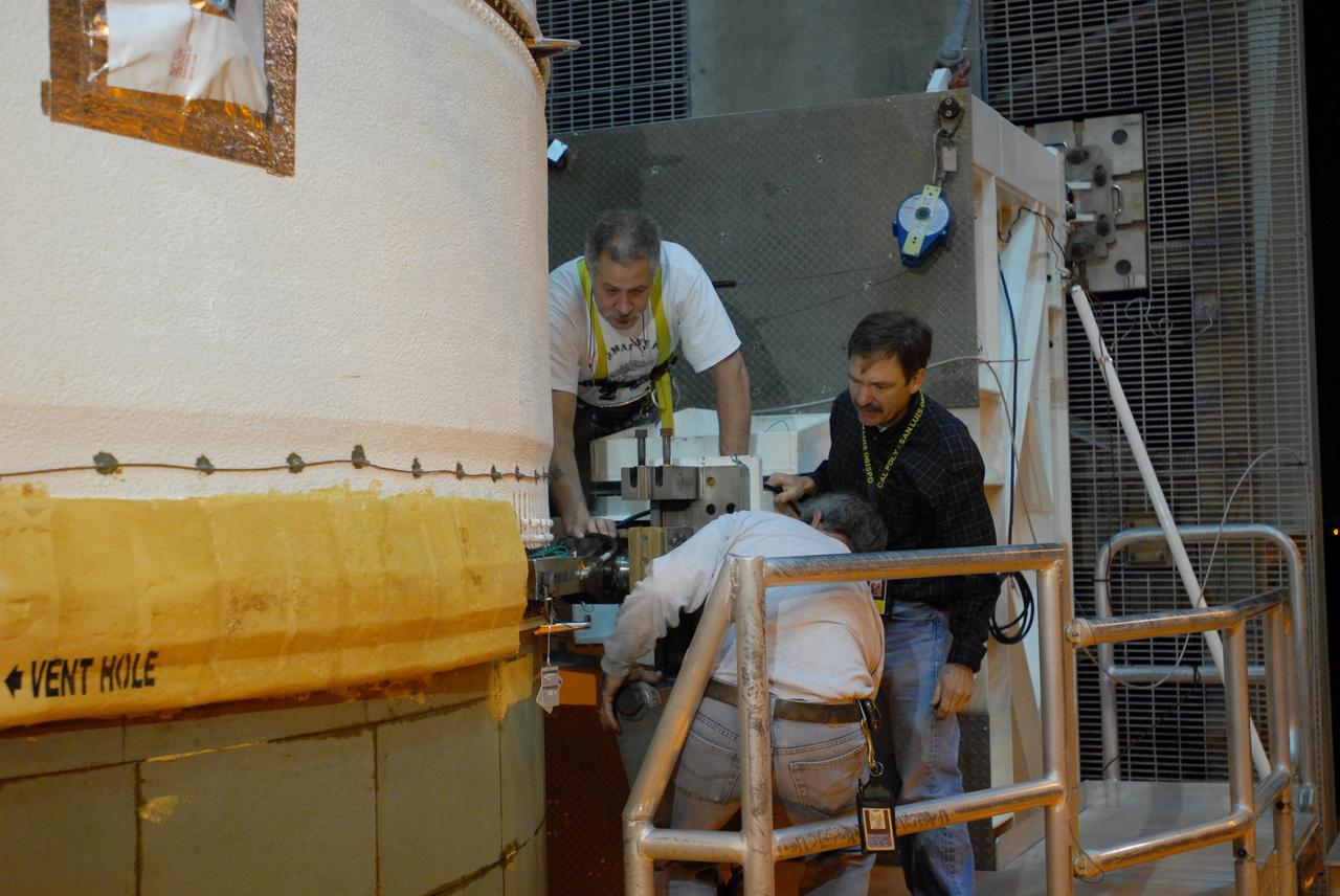 CAPE CANAVERAL, Fla. – On Launch Pad 37 at Cape Canaveral Air Force Station in Florida, workers begin detaching the lifting mechanism that raised the GOES-O and Delta IV upper stage to vertical. GOES–O is one of a series of Geostationary Operational Environmental Satellites. The multi-mission GOES series N-P will be a vital contributor to weather, solar and space operations and science. NASA and the National Oceanic and Atmospheric Administration, or NOAA, are actively engaged in a cooperative program to expand the existing GOES system with the launch of the GOES N-P satellites. Launch of the GOES-O is targeted for no earlier than April 2009. Photo credit: NASA/Jim Grossmann