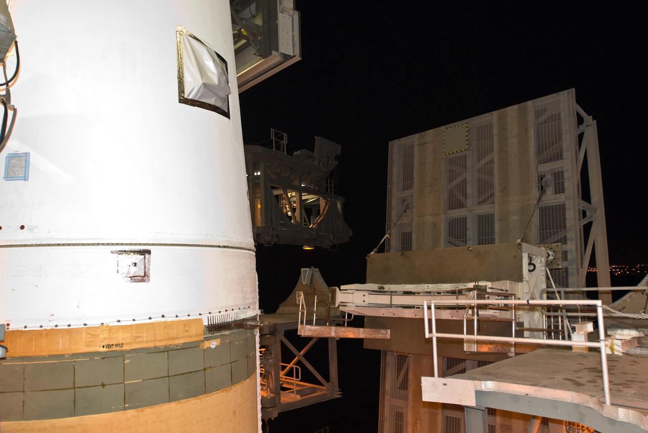 CAPE CANAVERAL, Fla. – On Launch Pad 37 at Cape Canaveral Air Force Station in Florida, the lifting mechanism that raised the GOES-O and Delta IV upper stage to vertical is being detached from the spacecraft-Delta stack. GOES–O is one of a series of Geostationary Operational Environmental Satellites. The multi-mission GOES series N-P will be a vital contributor to weather, solar and space operations and science. NASA and the National Oceanic and Atmospheric Administration, or NOAA, are actively engaged in a cooperative program to expand the existing GOES system with the launch of the GOES N-P satellites. Launch of the GOES-O is targeted for no earlier than April 2009. Photo credit: NASA/Jim Grossmann