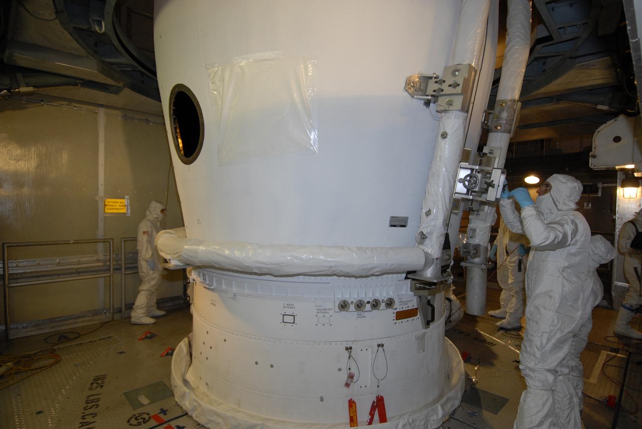 CAPE CANAVERAL, Fla. – On Launch Pad 17-B at Cape Canaveral Air Force Station in Florida, a worker examines the closure of the fairing segments around NASA's Kepler spacecraft. The fairing is a molded structure that fits flush with the outside surface of the rocket and forms an aerodynamically smooth nose cone, protecting the spacecraft during launch and ascent. The liftoff of Kepler aboard the Delta II rocket is currently targeted for launch in a window extending 10:49 to 10:52 p.m. EST March 6 from Pad 17-B. Kepler is designed to survey more than 100,000 stars in our galaxy to determine the number of sun-like stars that have Earth-size and larger planets, including those that lie in a star's "habitable zone," a region where liquid water, and perhaps life, could exist. If these Earth-size worlds do exist around stars like our sun, Kepler is expected to be the first to find them and the first to measure how common they are.  Photo credit: NASA/Jack Pfaller