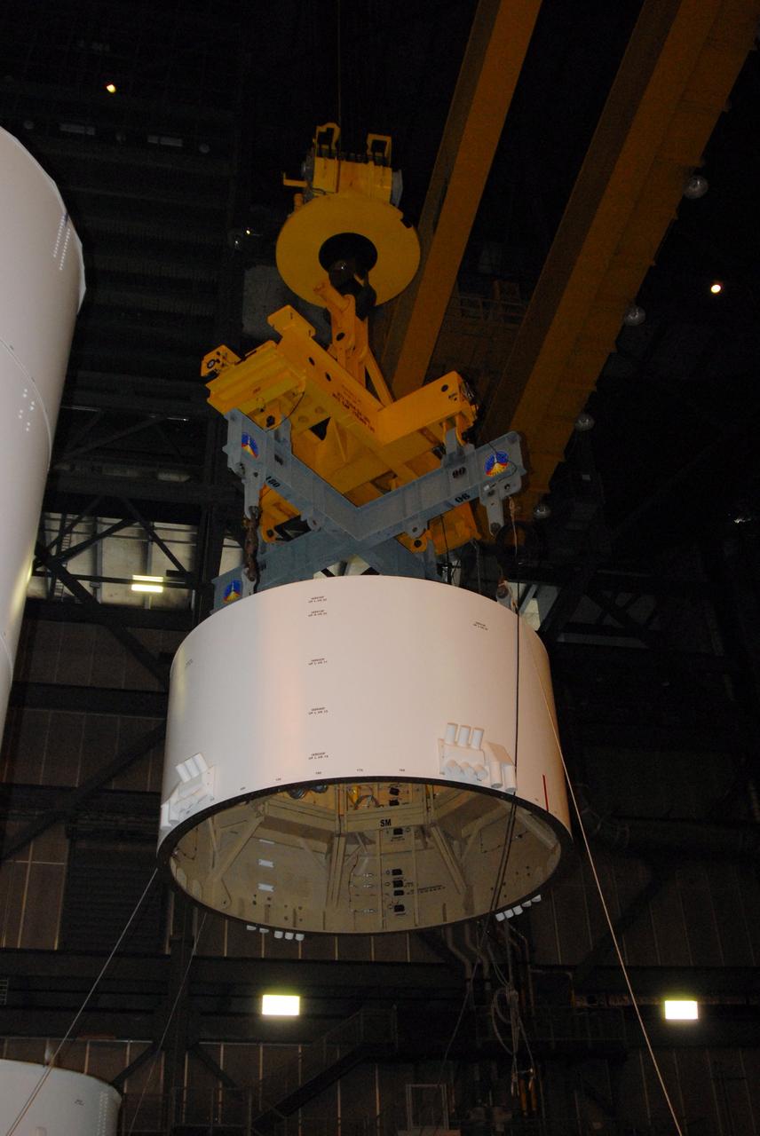 CAPE CANAVERAL, Fla. – In high bay 4 of the Vehicle Assembly Building at NASA's Kennedy Space Center in Florida, a large overhead crane lifts the Ares I-X service module, which will be mated to the service adapter in the bay.   Ares I-X is the test flight for the Ares I. The I-X flight will provide NASA an early opportunity to test and prove hardware, facilities and ground operations associated with Ares I. The launch of the 327-foot-tall, full-scale Ares I-X, targeted for July 2009, will be the first in a series of unpiloted rocket launches from Kennedy. Photo credit: NASA/Tim Jacobs