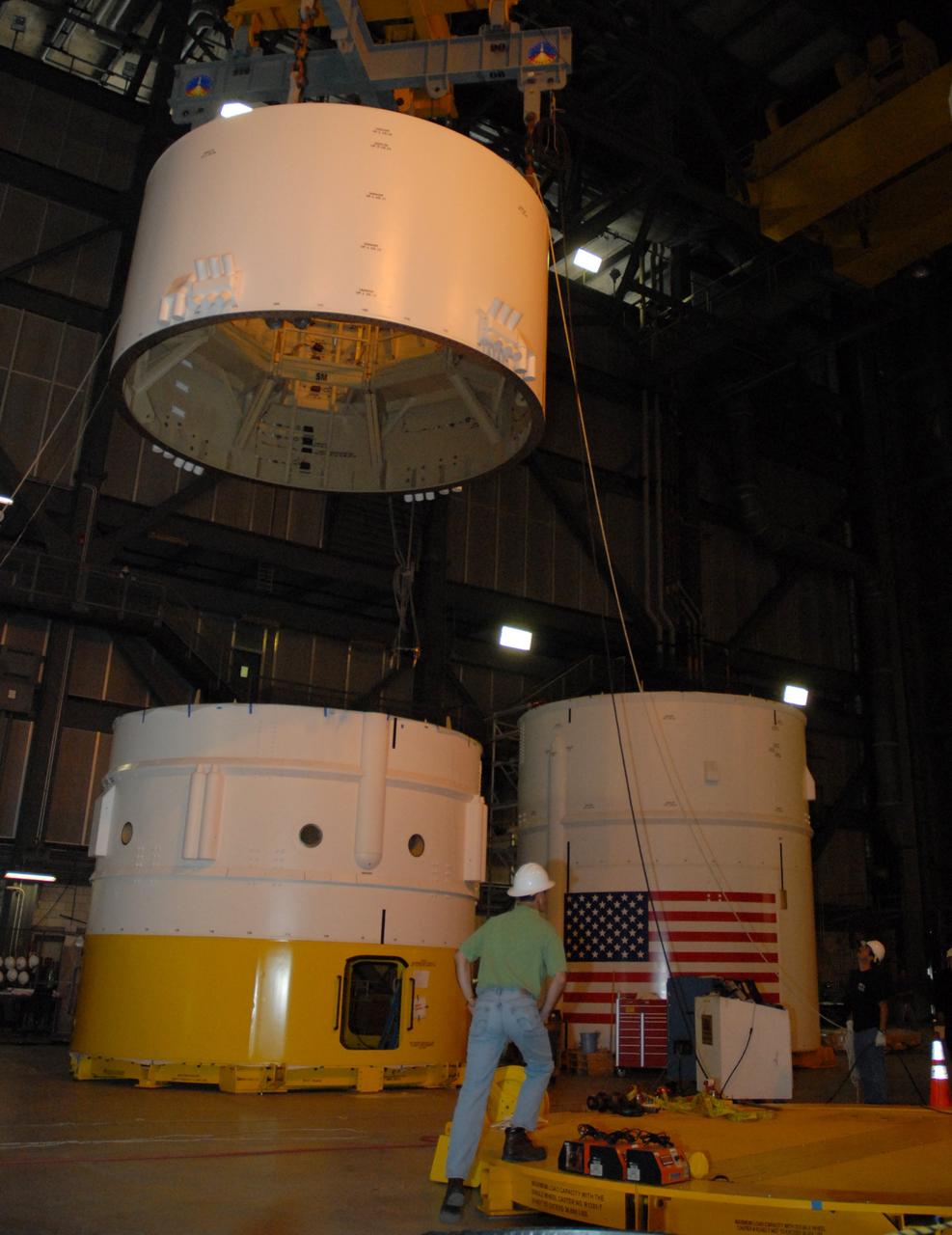 CAPE CANAVERAL, Fla. – In high bay 4 of the Vehicle Assembly Building at NASA's Kennedy Space Center in Florida, a large overhead crane moves the Ares I-X service module, which will be mated to the service adapter in the bay.  Other Ares I-X segments are located around the bay, as seen here.  Ares I-X is the test flight for the Ares I. The I-X flight will provide NASA an early opportunity to test and prove hardware, facilities and ground operations associated with Ares I. The launch of the 327-foot-tall, full-scale Ares I-X, targeted for July 2009, will be the first in a series of unpiloted rocket launches from Kennedy. Photo credit: NASA/Tim Jacobs