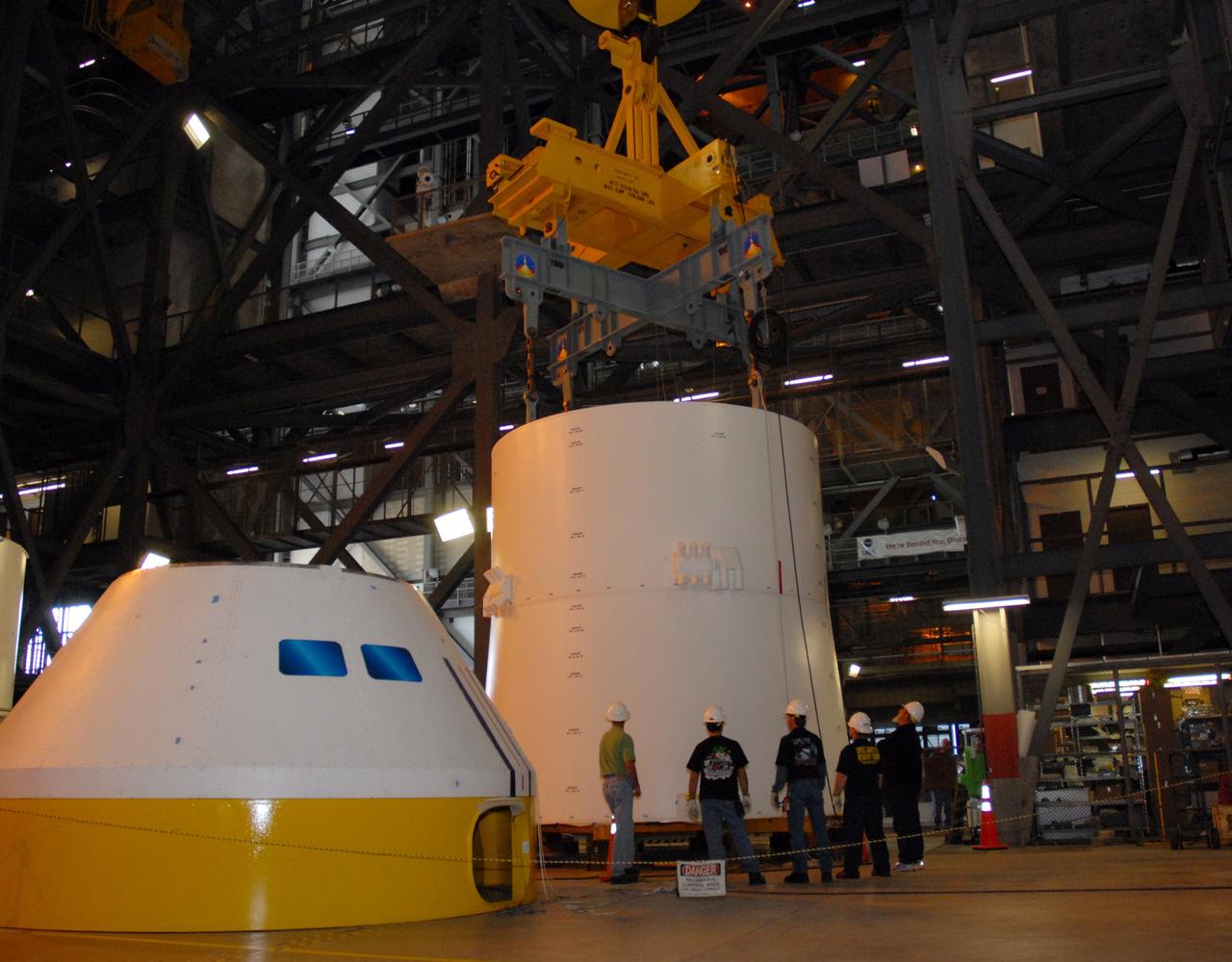 CAPE CANAVERAL, Fla. – In high bay 4 of the Vehicle Assembly Building at NASA's Kennedy Space Center in Florida, the installation of the Ares I-X service module onto the service adapter, at right, is complete.  At left is the simulator crew module. Ares I-X is the test flight for the Ares I. The I-X flight will provide NASA an early opportunity to test and prove hardware, facilities and ground operations associated with Ares I. The launch of the 327-foot-tall, full-scale Ares I-X, targeted for July 2009, will be the first in a series of unpiloted rocket launches from Kennedy. Photo credit: NASA/Tim Jacobs