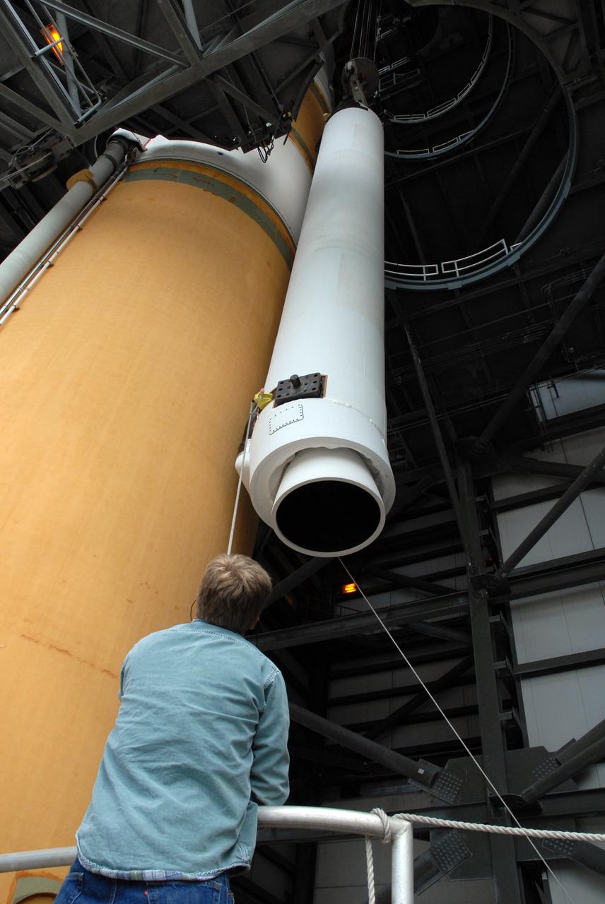 CAPE CANAVERAL, Fla. – On Launch Pad 37 at Cape Canaveral Air Force Station in Florida, the second of two solid rocket boosters is lowered alongside the Delta IV launch vehicle for the GOES-O spacecraft. It is being installed on the right side of the rocket. GOES–O is one of a series of Geostationary Operational Environmental Satellites. The multi-mission GOES series N-P will be a vital contributor to weather, solar and space operations and science. NASA and the National Oceanic and Atmospheric Administration, or NOAA, are actively engaged in a cooperative program to expand the existing GOES system with the launch of the GOES N-P satellites. Launch of the GOES-O is targeted for no earlier than April 2009. Photo credit: NASA/Jack Pfaller