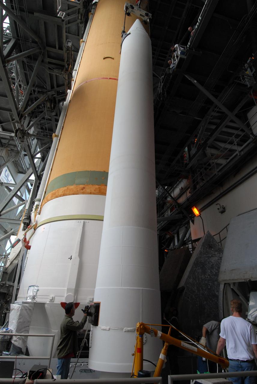 CAPE CANAVERAL, Fla. – On Launch Pad 37 at Cape Canaveral Air Force Station in Florida, the second of two solid rocket boosters is being installed on the right side of the Delta IV launch vehicle for the GOES-O spacecraft. GOES–O is one of a series of Geostationary Operational Environmental Satellites. The multi-mission GOES series N-P will be a vital contributor to weather, solar and space operations and science. NASA and the National Oceanic and Atmospheric Administration, or NOAA, are actively engaged in a cooperative program to expand the existing GOES system with the launch of the GOES N-P satellites. Launch of the GOES-O is targeted for no earlier than April 2009. Photo credit: NASA/Jack Pfaller