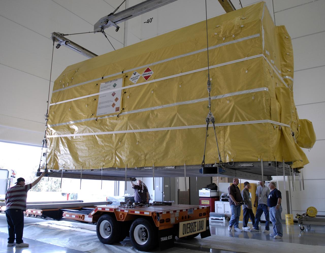 CAPE CANAVERAL, Fla. – The latest Geostationary Operational Environmental Satellite, or GOES, is lifted from the transporter and moved into the Astrotech payload processing facility in Titusville, Fla.  Developed by NASA for the National Oceanic and Atmospheric Administration, or NOAA, the GOES-O satellite is targeted to launch April 28 onboard a United Launch Alliance Delta IV expendable launch vehicle.  Once in orbit, GOES-O will be designated GOES-14, and NASA will provide on-orbit checkout and then transfer operational responsibility to NOAA. GOES-O will be placed in on-orbit storage as a replacement for an older GOES satellite.  The satellite will undergo final testing of the imaging system, instrumentation, communications and power systems. Photo credit: NASA/Kim Shiflett