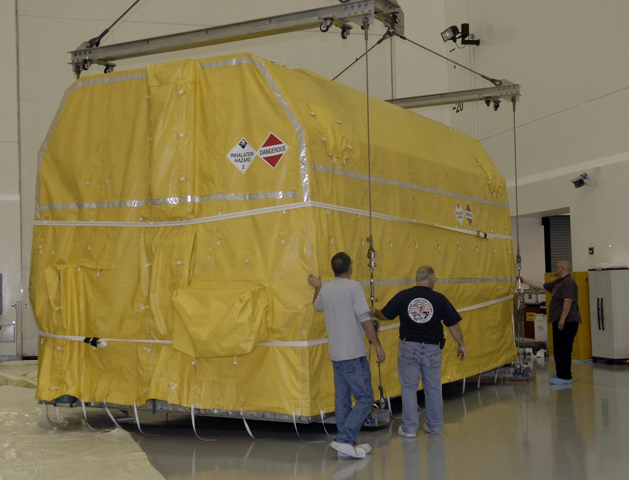 CAPE CANAVERAL, Fla. – In the Astrotech payload processing facility in Titusville, Fla., the latest Geostationary Operational Environmental Satellite, or GOES, is lowered onto the floor.  Developed by NASA for the National Oceanic and Atmospheric Administration, or NOAA, the GOES-O satellite is targeted to launch April 28 onboard a United Launch Alliance Delta IV expendable launch vehicle. Once in orbit, GOES-O will be designated GOES-14, and NASA will provide on-orbit checkout and then transfer operational responsibility to NOAA. GOES-O will be placed in on-orbit storage as a replacement for an older GOES satellite.  The satellite will undergo final testing of the imaging system, instrumentation, communications and power systems.  Photo credit: NASA/Kim Shiflett