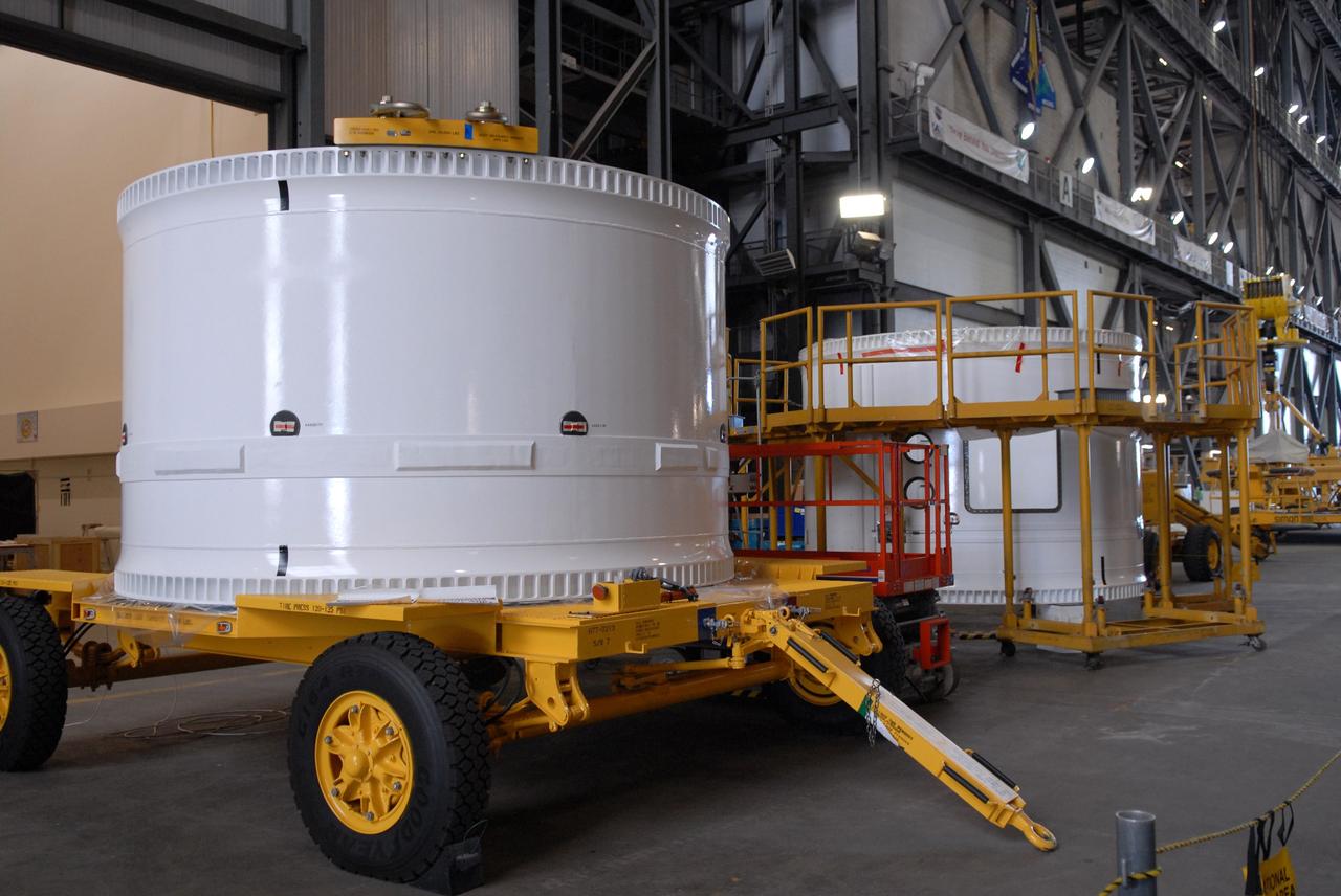 CAPE CANAVERAL, Fla. – In the Vehicle Assembly Building, the forward fifth segment simulator for the Ares I-X rocket is ready to be lifted for stacking with the center segment beside it.  Ares I-X is the test vehicle for the Ares I, which is part of the Constellation Program to return men to the moon and beyond. Ares I is the essential core of a safe, reliable, cost-effective space transportation system that eventually will carry crewed missions back to the moon, on to Mars and out into the solar system. Ares I-X is targeted for launch in July 2009.  Photo credit: NASA/Dimitri Gerondidakis