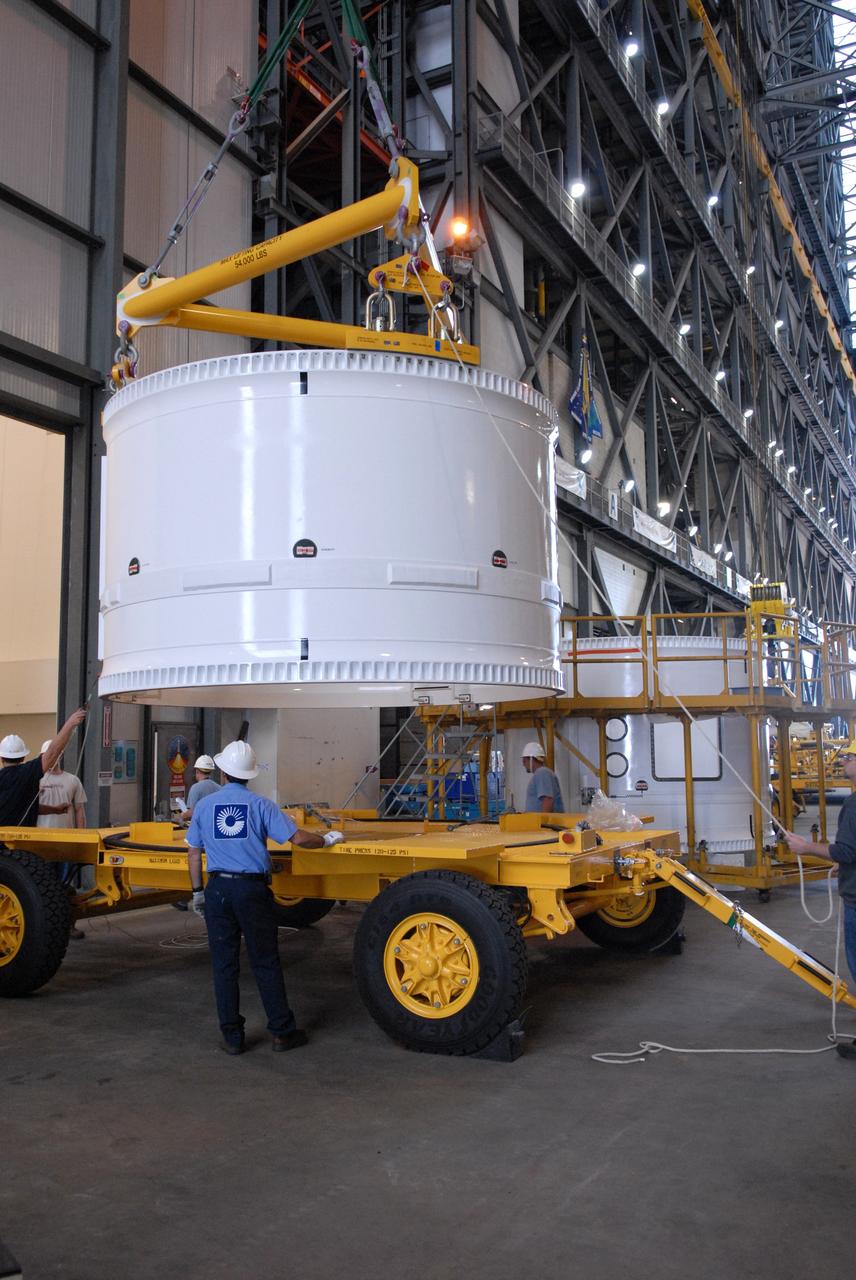 CAPE CANAVERAL, Fla. – In the Vehicle Assembly Building, the forward fifth segment simulator for the Ares I-X rocket is lifted from the transporter.  It will be stacked with the center segment beside it. Ares I-X is the test vehicle for the Ares I, which is part of the Constellation Program to return men to the moon and beyond. Ares I is the essential core of a safe, reliable, cost-effective space transportation system that eventually will carry crewed missions back to the moon, on to Mars and out into the solar system. Ares I-X is targeted for launch in July 2009.  Photo credit: NASA/Dimitri Gerondidakis
