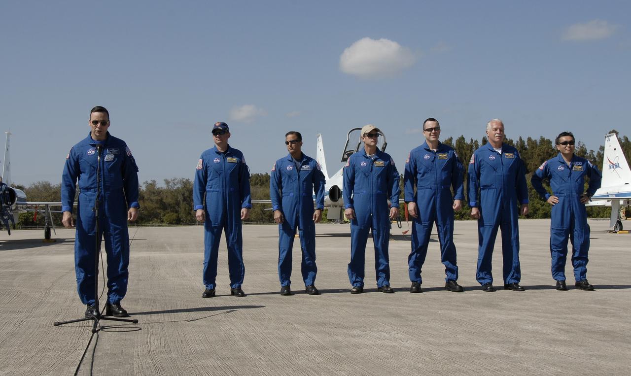 CAPE CANAVERAL, Fla. – The crew members for space shuttle Discovery's STS-119 mission address the news media on hand to welcome them upon their arrival at NASA's Kennedy Space Center in Florida to prepare for launch. From left are Commander Lee Archambault, at the microphone; Pilot Tony Antonelli; and Mission Specialists Joseph Acaba, Steve Swanson, Richard Arnold, John Phillips and Koichi Wakata of the Japan Aerospace Exploration Agency. STS-119 is the 125th space shuttle flight and the 28th flight to the International Space Station. Discovery and its crew will deliver the final set of large power-generating solar array wings and integrated truss structure, S6, to the space station. The mission includes four spacewalks. Launch is scheduled for March 11 at 9:20 p.m. EDT. Photo credit: NASA/Kim Shiflett
