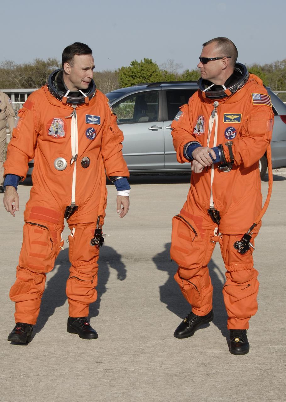 CAPE CANAVERAL, Fla. – On the Shuttle Landing Facility at NASA's Kennedy Space Center in Florida, STS-119 Commander Lee Archambault and Pilot Tony Antonelli, wearing their launch-and-entry suits, head for the Shuttle Training Aircraft to practice shuttle landings. The mission crew members arrived in the afternoon at Kennedy to prepare for launch. The mission is the 28th to the International Space Station and the 125th space shuttle flight.  Space shuttle Discovery will deliver the final pair of power-generating solar array wings and truss element, S6.  Photo credit: NASA/Kim Shiflett