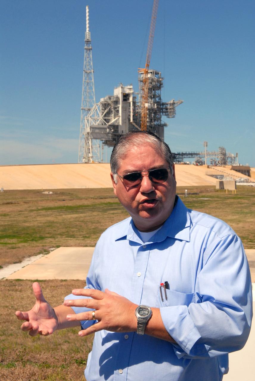 CAPE CANAVERAL, Fla. – Near Launch Pad 39B at NASA's Kennedy Space Center in Florida, Jose Perez-Morales explains use of the launch pad for the Ares rockets in the Constellation Program. Perez-Morales is Constellation senior pad project manager. Pad 39B will be used for the Ares I-X flight test, targeted for July 2009.  The I-X flight will provide NASA an early opportunity to test and prove hardware, facilities and ground operations associated with Ares I,  part of the Constellation Program to return men to the moon and beyond. Ares I is the essential core of a safe, reliable, cost-effective space transportation system that eventually will carry crewed missions back to the moon, on to Mars and out into the solar system. Photo credit: NASA/Jack Pfaller