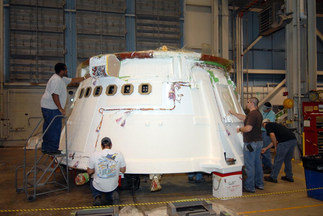 CAPE CANAVERAL, Fla. – In the Assembly and Refurbishment Facility at NASA's Kennedy Space Center in Florida, the aft skirt for the Ares I-X flight test is displayed for the media.  The I-X flight will provide NASA an early opportunity to test and prove hardware, facilities and ground operations associated with Ares I,  part of the Constellation Program to return men to the moon and beyond. Ares I is the essential core of a safe, reliable, cost-effective space transportation system that eventually will carry crewed missions back to the moon, on to Mars and out into the solar system. Photo credit: NASA/Jack Pfaller