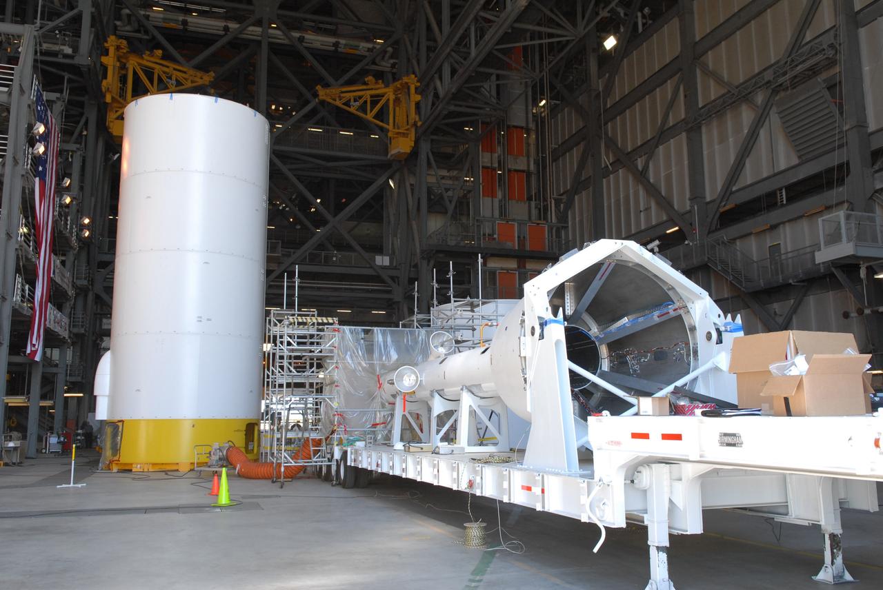 CAPE CANAVERAL, Fla. – Simulator segments of the Ares I-X are on display for the media in the Vehicle Assembly Building at NASA's Kennedy Space Center in Florida. At left are several stacked segments. At right is the launch abort system simulator. The I-X flight will provide NASA an early opportunity to test and prove hardware, facilities and ground operations associated with Ares I, part of the Constellation Program to return men to the moon and beyond. Ares I is the essential core of a safe, reliable, cost-effective space transportation system that eventually will carry crewed missions back to the moon, on to Mars and out into the solar system. Photo credit: NASA/Jack Pfaller