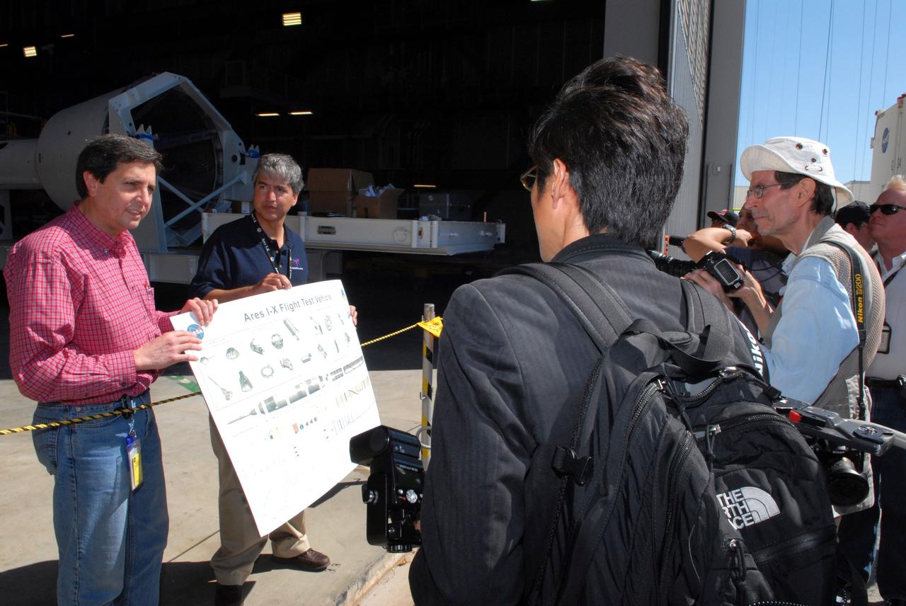 CAPE CANAVERAL, Fla. – Media, at right, gather outside the Vehicle Assembly Building at NASA's Kennedy Space Center in Florida to get more details about the Ares I-X flight test system. The I-X flight will provide NASA an early opportunity to test and prove hardware, facilities and ground operations associated with Ares I,  part of the Constellation Program to return men to the moon and beyond. Ares I is the essential core of a safe, reliable, cost-effective space transportation system that eventually will carry crewed missions back to the moon, on to Mars and out into the solar system. Photo credit: NASA/Jack Pfaller