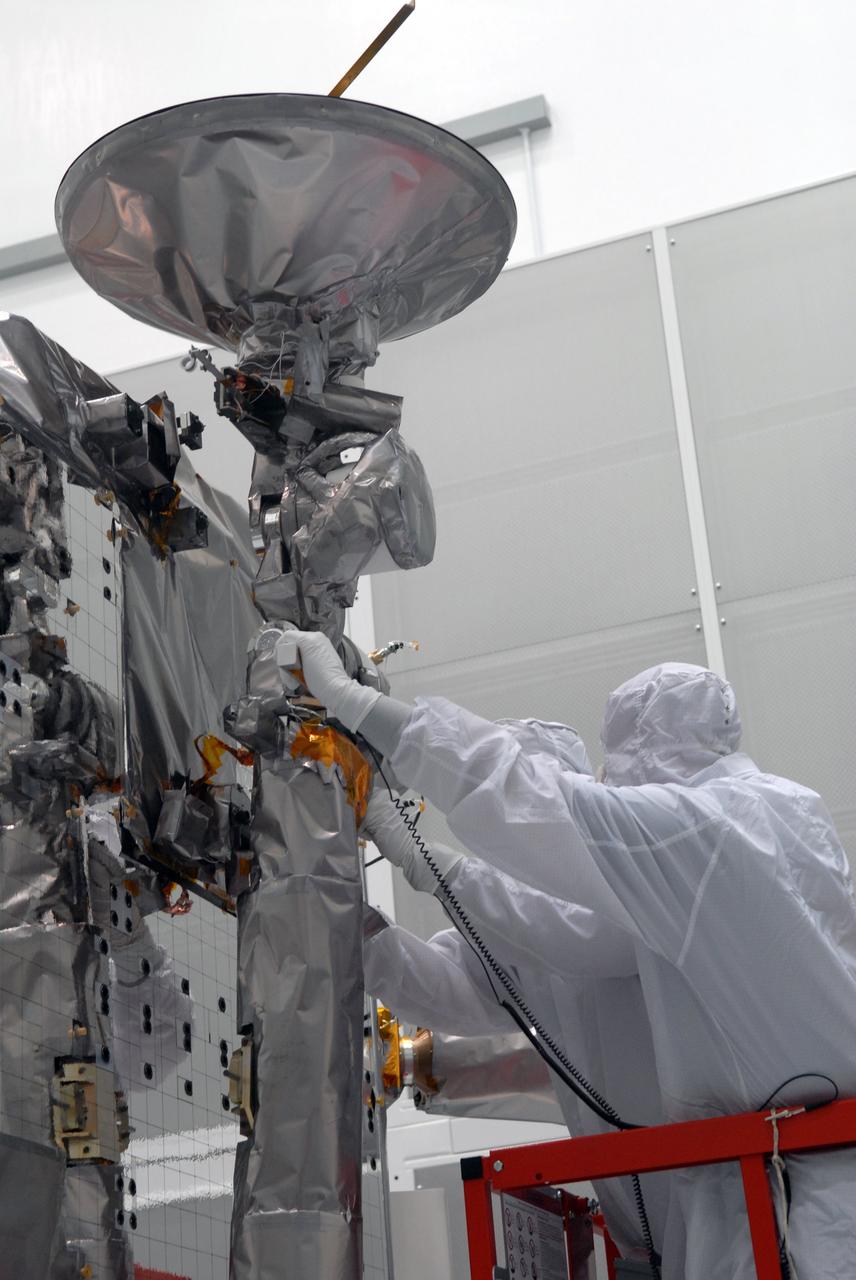 CAPE CANAVERAL, Fla. – At Astrotech in Titusville, Fla., a technician attaches cables to NASA's Lunar Reconnaissance Orbiter, or LRO.  The orbiter will be rotated on the table to provide proper access for processing. The orbiter will carry seven instruments to provide scientists with detailed maps of the lunar surface and enhance our understanding of the moon's topography, lighting conditions, mineralogical composition and natural resources. Information gleaned from LRO will be used to select safe landing sites, determine locations for future lunar outposts and help mitigate radiation dangers to astronauts. The polar regions of the moon are the main focus of the mission because continuous access to sunlight may be possible and water ice may exist in permanently shadowed areas of the poles. Accompanying LRO on its journey to the moon will be the Lunar CRater Observation and Sensing Satellite, or LCROSS, a mission that will impact the lunar surface in its search for water ice. Launch of LRO is targeted for May 20.   Photo credit: NASA/Jack Pfaller