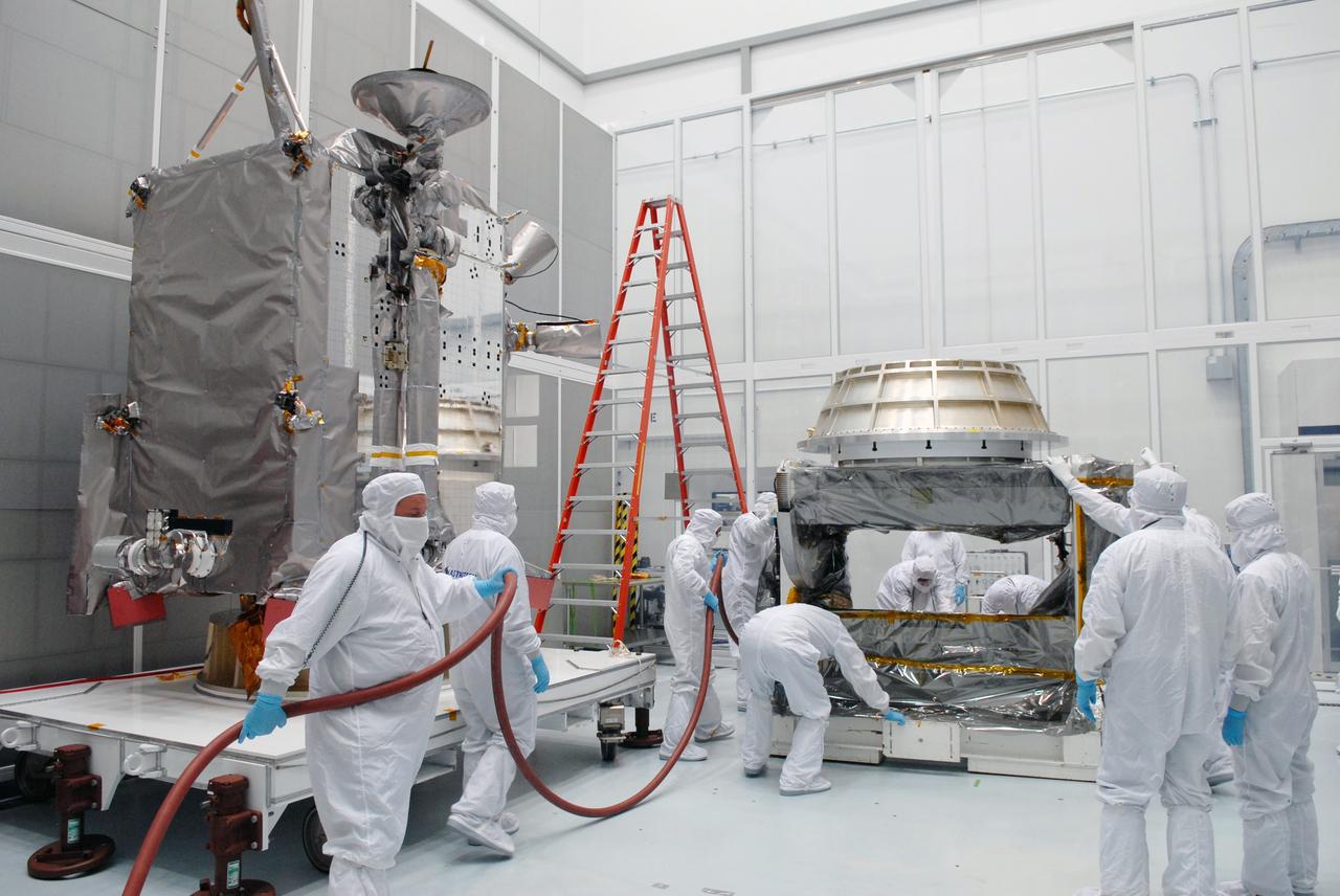 CAPE CANAVERAL, Fla. – At Astrotech in Titusville, Fla., technicians prepare an Aronson table to receive NASA's Lunar Reconnaissance Orbiter, or LRO, at left.  The orbiter will be rotated on the table to provide proper access for processing. The orbiter will carry seven instruments to provide scientists with detailed maps of the lunar surface and enhance our understanding of the moon's topography, lighting conditions, mineralogical composition and natural resources. Information gleaned from LRO will be used to select safe landing sites, determine locations for future lunar outposts and help mitigate radiation dangers to astronauts. The polar regions of the moon are the main focus of the mission because continuous access to sunlight may be possible and water ice may exist in permanently shadowed areas of the poles. Accompanying LRO on its journey to the moon will be the Lunar CRater Observation and Sensing Satellite, or LCROSS, a mission that will impact the lunar surface in its search for water ice. Launch of LRO is targeted for May 20.   Photo credit: NASA/Jack Pfaller