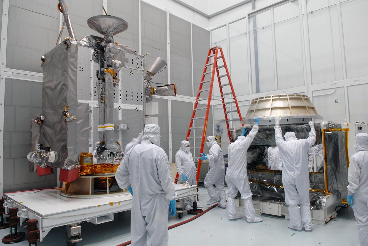 CAPE CANAVERAL, Fla. – At Astrotech in Titusville, Fla., technicians prepare an Aronson table to receive NASA's Lunar Reconnaissance Orbiter, or LRO, at left.  The orbiter will be rotated on the table to provide proper access for processing. The orbiter will carry seven instruments to provide scientists with detailed maps of the lunar surface and enhance our understanding of the moon's topography, lighting conditions, mineralogical composition and natural resources. Information gleaned from LRO will be used to select safe landing sites, determine locations for future lunar outposts and help mitigate radiation dangers to astronauts. The polar regions of the moon are the main focus of the mission because continuous access to sunlight may be possible and water ice may exist in permanently shadowed areas of the poles. Accompanying LRO on its journey to the moon will be the Lunar CRater Observation and Sensing Satellite, or LCROSS, a mission that will impact the lunar surface in its search for water ice. Launch of LRO is targeted for May 20.   Photo credit: NASA/Jack Pfaller