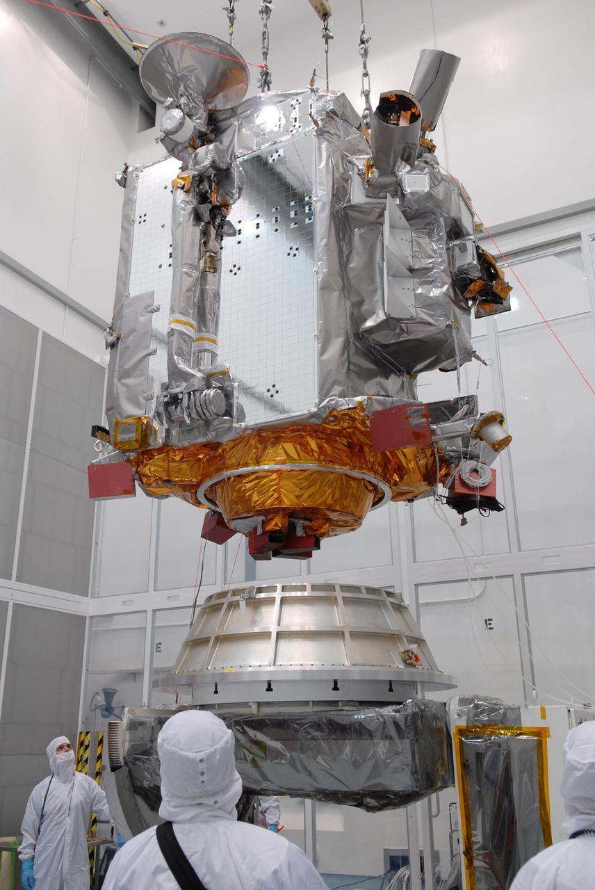 CAPE CANAVERAL, Fla. – At Astrotech in Titusville, Fla., an overhead crane lowers NASA's Lunar Reconnaissance Orbiter, or LRO, toward the Aronson table.  The orbiter will be rotated on the table to provide proper access for processing. The orbiter will carry seven instruments to provide scientists with detailed maps of the lunar surface and enhance our understanding of the moon's topography, lighting conditions, mineralogical composition and natural resources. Information gleaned from LRO will be used to select safe landing sites, determine locations for future lunar outposts and help mitigate radiation dangers to astronauts. The polar regions of the moon are the main focus of the mission because continuous access to sunlight may be possible and water ice may exist in permanently shadowed areas of the poles. Accompanying LRO on its journey to the moon will be the Lunar CRater Observation and Sensing Satellite, or LCROSS, a mission that will impact the lunar surface in its search for water ice. Launch of LRO is targeted for May 20.   Photo credit: NASA/Jack Pfaller