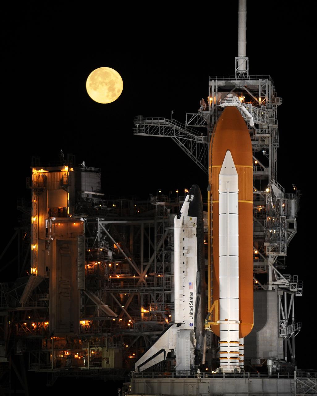 CAPE CANAVERAL, Fla. – Under a full moon on Launch Pad 39A at NASA's Kennedy Space Center in Florida, space shuttle Discovery is revealed after the rotating service structure has been rolled back.  The rollback is in preparation for Discovery's liftoff on the STS-119 mission with a crew of seven. The rotating structure provides protected access to the shuttle for changeout and servicing of payloads at the pad. It is supported by a rotating bridge that pivots on a vertical axis on the west side of the pad's flame trench. After the RSS is rolled back, the orbiter is ready for fuel cell activation and external tank cryogenic propellant loading operations. The mission is the 28th to the International Space Station and the 125th space shuttle flight.  Discovery will deliver the final pair of power-generating solar array wings and the S6 truss segment.  Installation of S6 will signal the station's readiness to house a six-member crew for conducting increased science.  Liftoff of Discovery is scheduled for 9:20 p.m. EDT on March 11.  Photo courtesy of NASA/Bill Ingalls