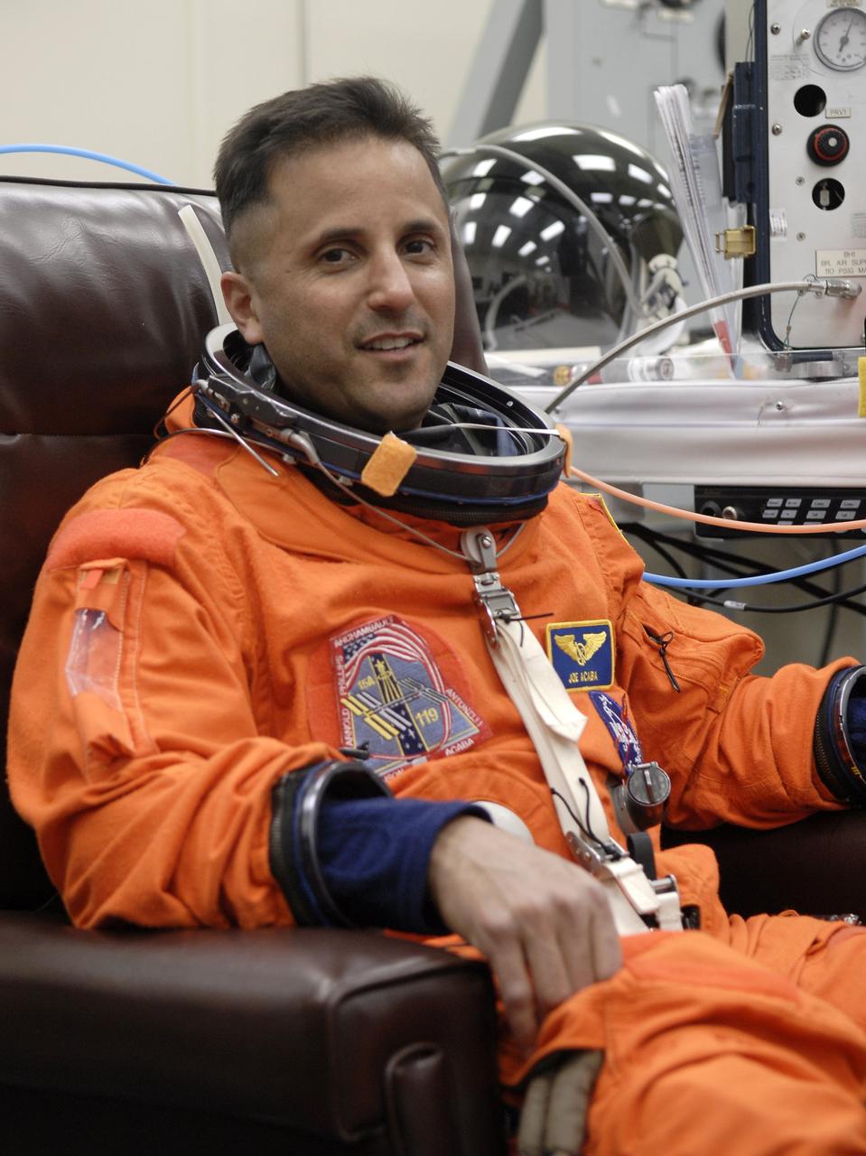 CAPE CANAVERAL, Fla. – – In the Operations and Checkout Building at NASA's Kennedy Space Center in Florida, STS-119 Mission Specialist Joseph Acaba has a final fitting of his launch and entry suit.  Acaba is making his first shuttle flight. The 14-day mission is the 28th to the International Space Station and the 125th space shuttle flight.  Discovery will deliver the final pair of power-generating solar array wings and the S6 truss segment.  Installation of S6 will signal the station's readiness to house a six-member crew for conducting increased science.  Liftoff of Discovery is scheduled for 9:20 p.m. EDT on March 11.   Photo credit: NASA/Kim Shiflett
