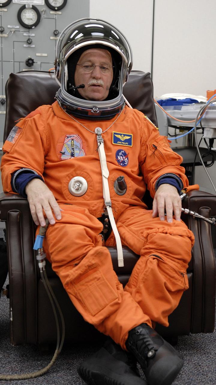 CAPE CANAVERAL, Fla. – In the Operations and Checkout Building at NASA's Kennedy Space Center in Florida, STS-119 Mission Specialist John Phillips has a final fitting of his launch and entry suit and the helmet. Phillips is making his third shuttle flight. The 14-day mission is the 28th to the International Space Station and the 125th space shuttle flight. Discovery will deliver the final pair of power-generating solar array wings and the S6 truss segment. Installation of S6 will signal the station's readiness to house a six-member crew for conducting increased science. Liftoff of Discovery is scheduled for 9:20 p.m. EDT on March 11. Photo credit: NASA/Kim Shiflett