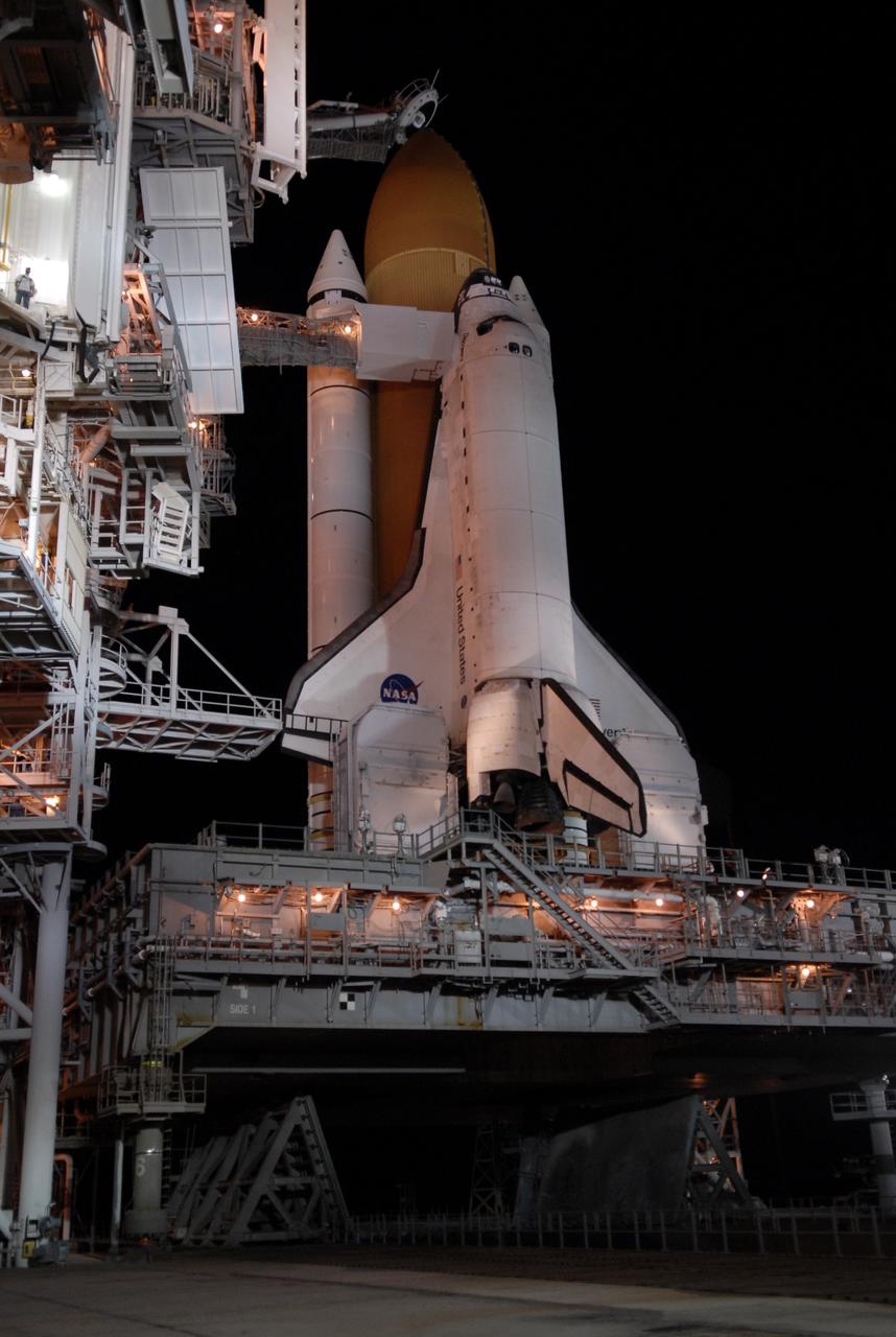 CAPE CANAVERAL, Fla. – On Launch Pad 39A at NASA's Kennedy Space Center in Florida, the orbiter access arm and White Room are extended toward space shuttle Discovery after rollback of the rotating service structure. The White Room provides crew access into the shuttle. Above the external tank is the oxygen vent hood, called the "beanie cap."  The rollback is in preparation for Discovery's liftoff on the STS-119 mission with a crew of seven. The rotating structure provides protected access to the shuttle for changeout and servicing of payloads at the pad. After the RSS is rolled back, the orbiter is ready for fuel cell activation and external tank cryogenic propellant loading operations. The mission is the 28th to the International Space Station and the 125th space shuttle flight.  Discovery will deliver the final pair of power-generating solar array wings and the S6 truss segment.  Installation of S6 will signal the station's readiness to house a six-member crew for conducting increased science.  Liftoff of Discovery is scheduled for 9:20 p.m. EDT on March 11.   Photo credit: NASA/Kim Shiflett