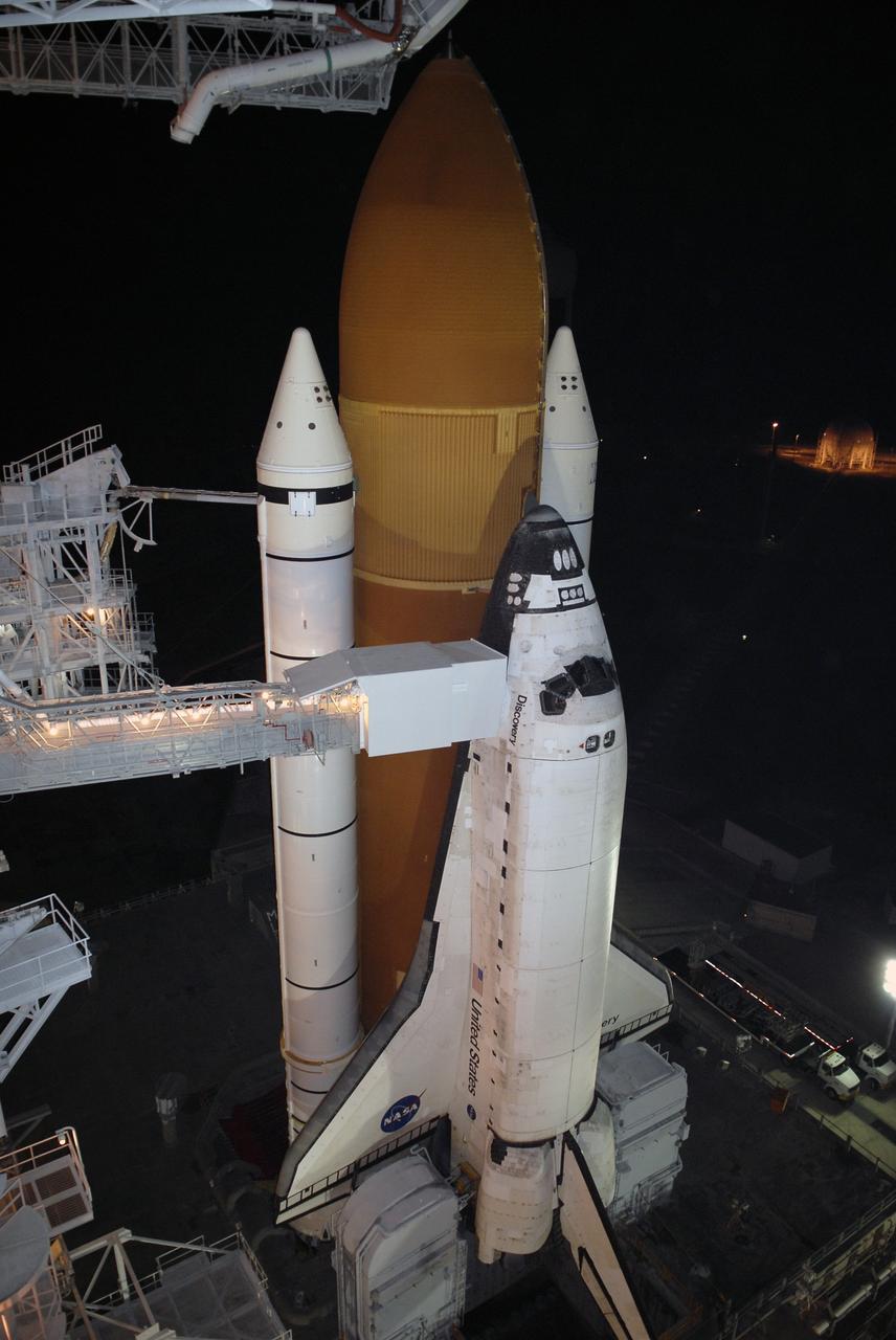 CAPE CANAVERAL, Fla. – On Launch Pad 39A at NASA's Kennedy Space Center in Florida, the orbiter access arm and White Room are extended toward space shuttle Discovery after rollback of the rotating service structure. The White Room provides crew access into the shuttle. The rollback is in preparation for Discovery's liftoff on the STS-119 mission with a crew of seven. The rotating structure provides protected access to the shuttle for changeout and servicing of payloads at the pad. After the RSS is rolled back, the orbiter is ready for fuel cell activation and external tank cryogenic propellant loading operations. The mission is the 28th to the International Space Station and the 125th space shuttle flight.  Discovery will deliver the final pair of power-generating solar array wings and the S6 truss segment.  Installation of S6 will signal the station's readiness to house a six-member crew for conducting increased science.  Liftoff of Discovery is scheduled for 9:20 p.m. EDT on March 11.   Photo credit: NASA/Kim Shiflett