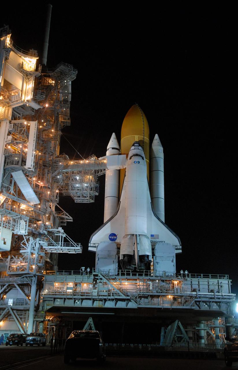 CAPE CANAVERAL, Fla. – On Launch Pad 39A at NASA's Kennedy Space Center in Florida, the orbiter access arm and White Room are extended toward space shuttle Discovery after rollback of the rotating service structure. The White Room provides crew access into the shuttle. The rollback is in preparation for Discovery's liftoff on the STS-119 mission with a crew of seven. An earlier launch attempt March 11 was scrubbed at 2:36 p.m. due to a gaseous hydrogen leak from the external tank at the Ground Umbilical Carrier Plate during tanking. A seven-inch quick disconnect and two seals were replaced. The STS-119 mission is the 28th to the International Space Station and the 125th space shuttle flight.  Discovery will deliver the final pair of power-generating solar array wings and the S6 truss segment.  Installation of S6 will signal the station's readiness to house a six-member crew for conducting increased science.  Liftoff of Discovery is scheduled for 7:43 p.m. EDT on March 15.   Photo credit: NASA/Jack Pfaller