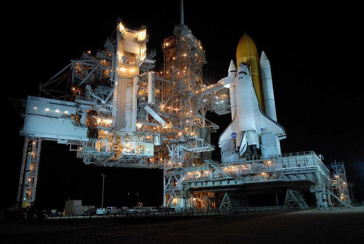 CAPE CANAVERAL, Fla. – Lights glow on the structures on Launch Pad 39A at NASA's Kennedy Space Center in Florida, after rollback of the rotating service structure from around space shuttle Discovery. The orbiter access arm and White Room are extended toward Discovery The White Room provides crew access into the shuttle.  The rollback is in preparation for Discovery's liftoff on the STS-119 mission with a crew of seven. An earlier launch attempt March 11 was scrubbed at 2:36 p.m. due to a gaseous hydrogen leak from the external tank at the Ground Umbilical Carrier Plate during tanking. A seven-inch quick disconnect and two seals were replaced. The STS-119 mission is the 28th to the International Space Station and the 125th space shuttle flight.  Discovery will deliver the final pair of power-generating solar array wings and the S6 truss segment.  Installation of S6 will signal the station's readiness to house a six-member crew for conducting increased science.  Liftoff of Discovery is scheduled for 7:43 p.m. EDT on March 15.   Photo credit: NASA/Jack Pfaller