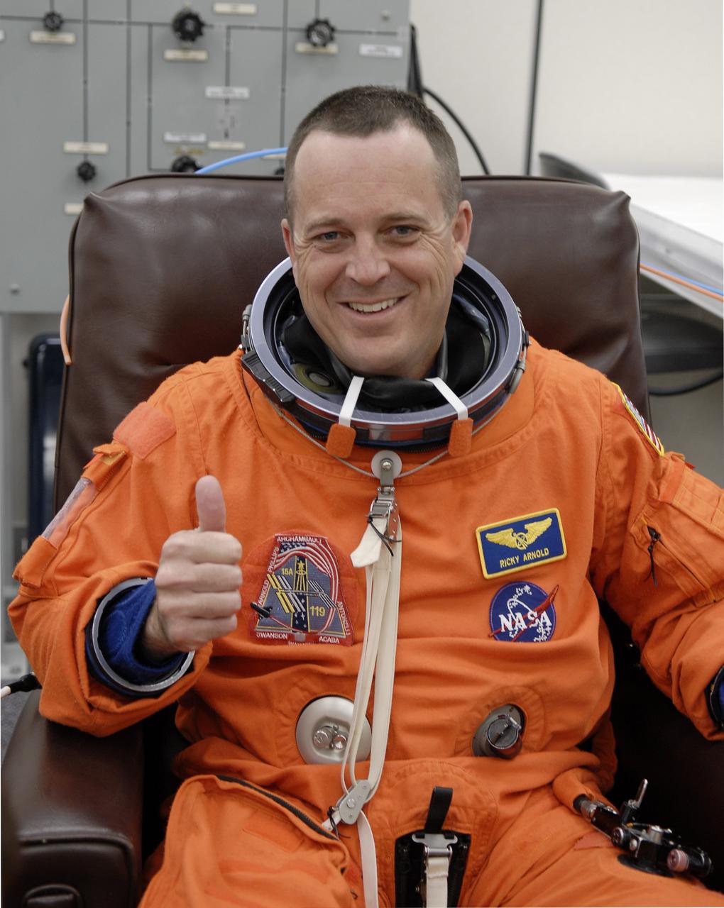 CAPE CANAVERAL, Fla. – In the Operations and Checkout Building at NASA's Kennedy Space Center in Florida, STS-119 Mission Specialist Richard Arnold  is eager for launch as he puts on his launch-and-entry suit.  The crew will be heading for Launch Pad 39A and liftoff of space shuttle Discovery, scheduled for 7:43 p.m. EDT on March 15.  An earlier launch attempt March 11 was scrubbed at 2:36 p.m. due to a gaseous hydrogen leak from the external tank at the Ground Umbilical Carrier Plate during tanking. A seven-inch quick disconnect and two seals were replaced. The STS-119 mission is the 28th to the International Space Station and the 125th space shuttle flight.  Discovery will deliver the final pair of power-generating solar array wings and the S6 truss segment.  Installation of S6 will signal the station's readiness to house a six-member crew for conducting increased science.  Photo credit: NASA/Kim Shiflett