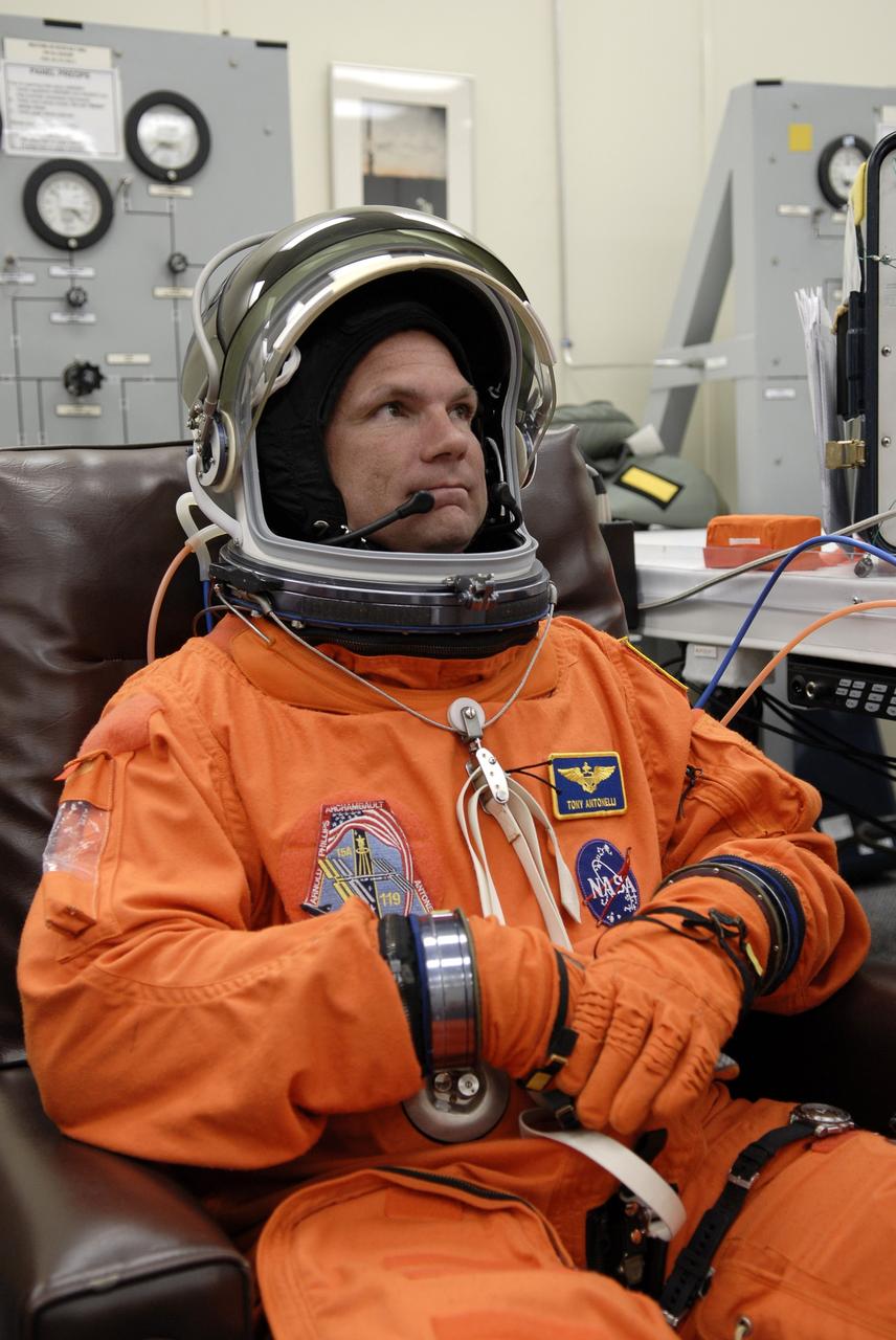 CAPE CANAVERAL, Fla. – – In the Operations and Checkout Building at NASA's Kennedy Space Center in Florida, STS-119 Pilot Tony Antonelli adds the helmet as he puts on his launch-and-entry suit for the launch of space shuttle Discovery.  The crew will be heading for Launch Pad 39A and liftoff of Discovery, scheduled for 7:43 p.m. EDT on March 15. An earlier launch attempt March 11 was scrubbed at 2:36 p.m. due to a gaseous hydrogen leak from the external tank at the Ground Umbilical Carrier Plate during tanking. A seven-inch quick disconnect and two seals were replaced. The STS-119 mission is the 28th to the International Space Station and the 125th space shuttle flight.  Discovery will deliver the final pair of power-generating solar array wings and the S6 truss segment.  Installation of S6 will signal the station's readiness to house a six-member crew for conducting increased science.  Photo credit: NASA/Kim Shiflett